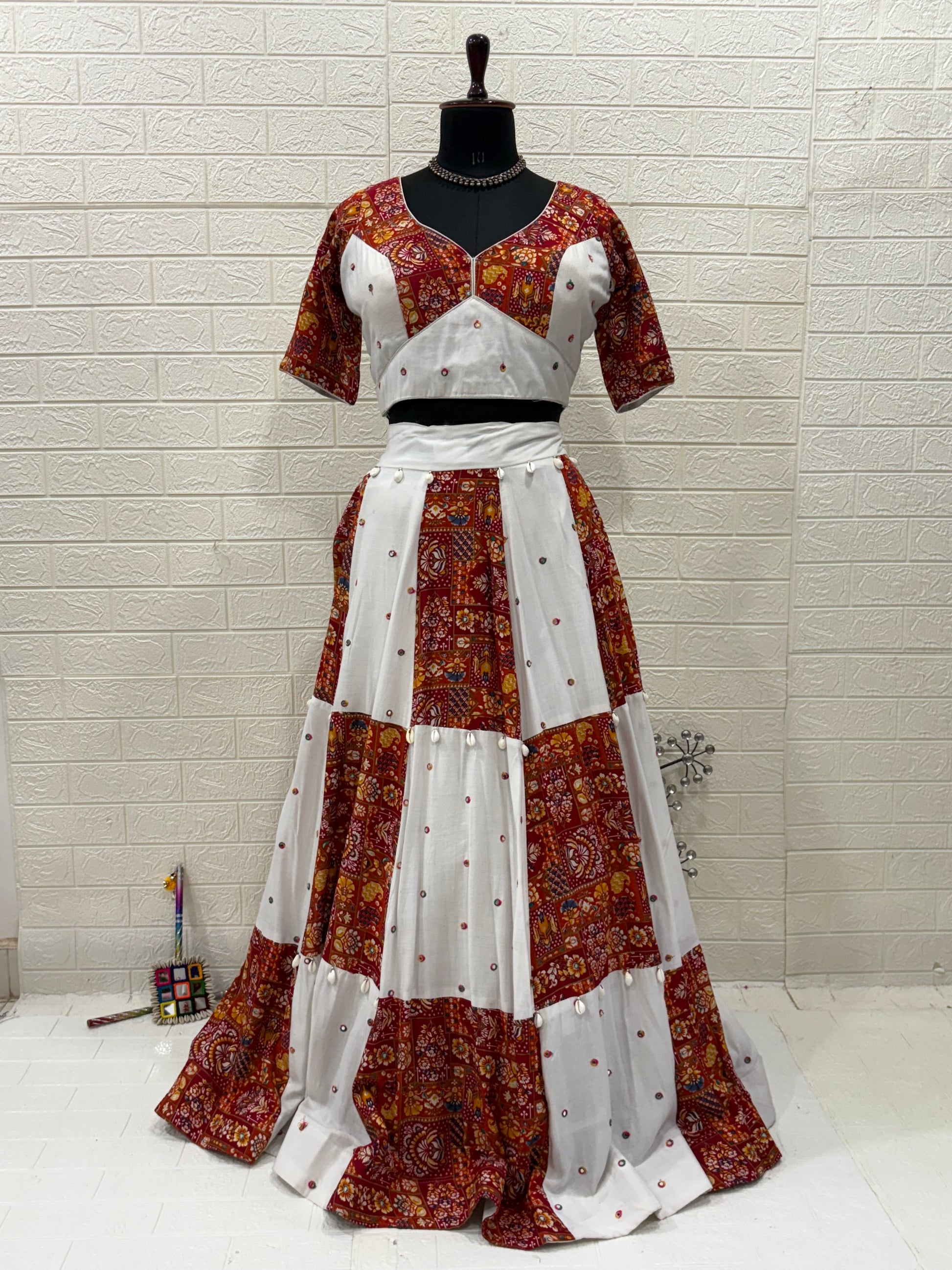 Name:
Rust & Ivory Ajrakh Lehenga Handcrafted soft cotton lehenga with cowrie shell in rust ajrakh and ivory panels, paired with a matching White dupatta with playful perfect for a vibrant Navratri look.