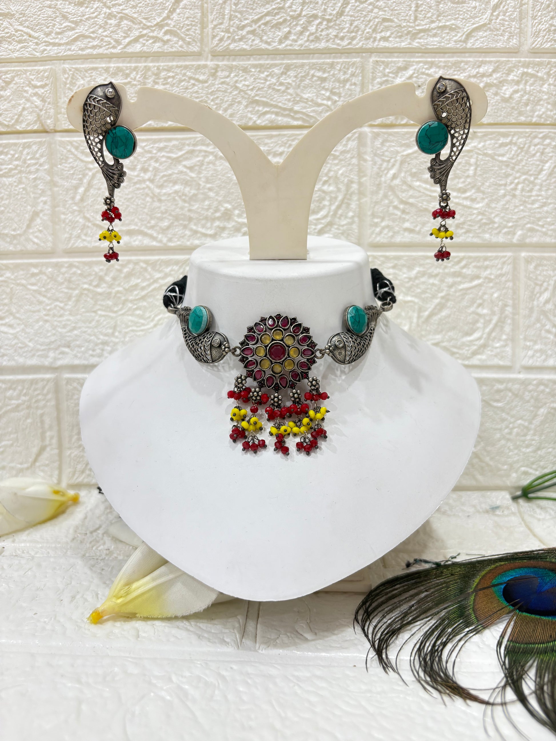 Name: Meenakari Fish Motif Choker Set
Collection: Boho Tribal Jewellery
Colour: Oxidised Silver with Multicolour Beads (Red, Yellow, Green) and Turquoise Stone