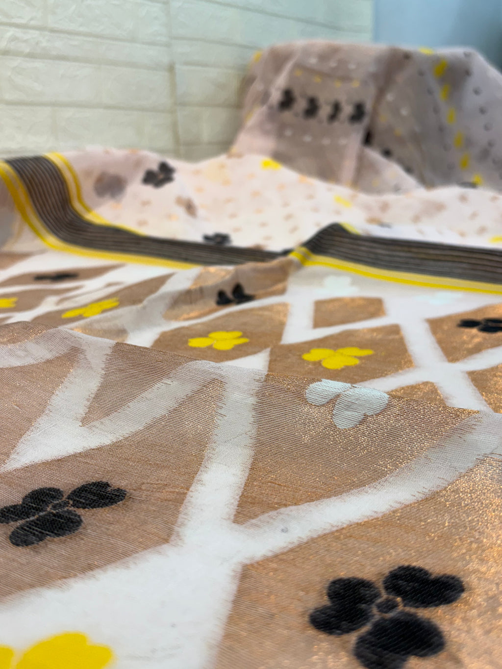 Pastel light pink Jamdani Saree cotton Jamdani, featuring geometric diamond motifs with delicate floral buttas and a soft, airy handwoven texture