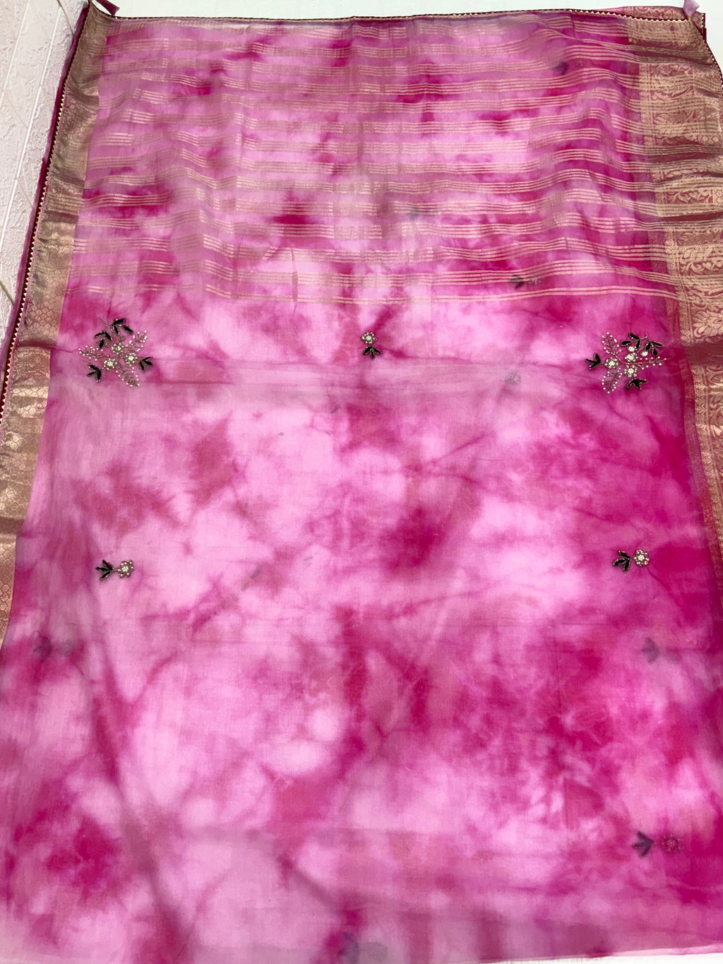 Name: Pink Ombre Organza Saree Soft organza with zari-woven golden border and delicate sequin floral embroidery, giving a graceful festive look.