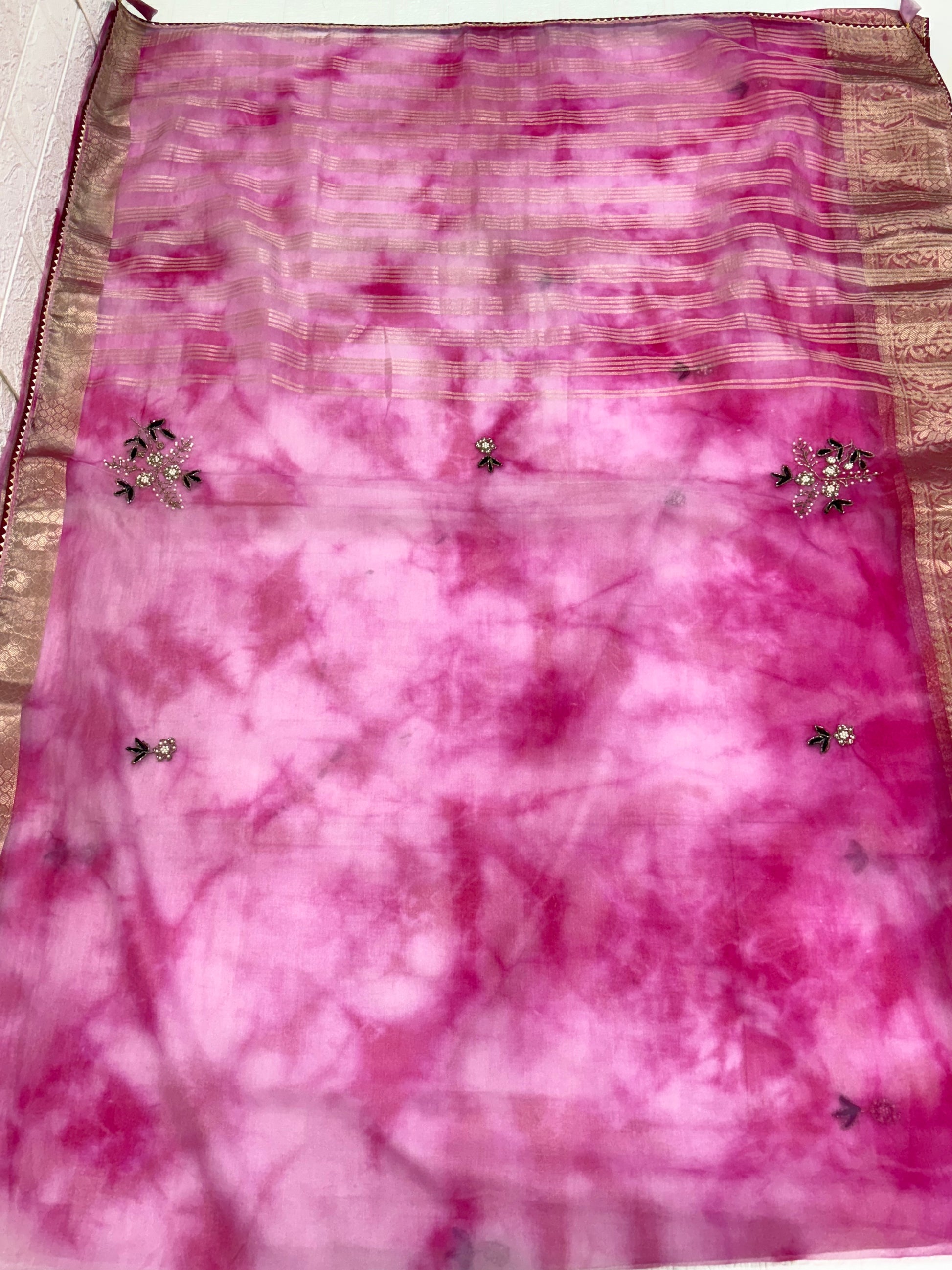 Name: Pink Ombre Organza Saree Soft organza with zari-woven golden border and delicate sequin floral embroidery, giving a graceful festive look.