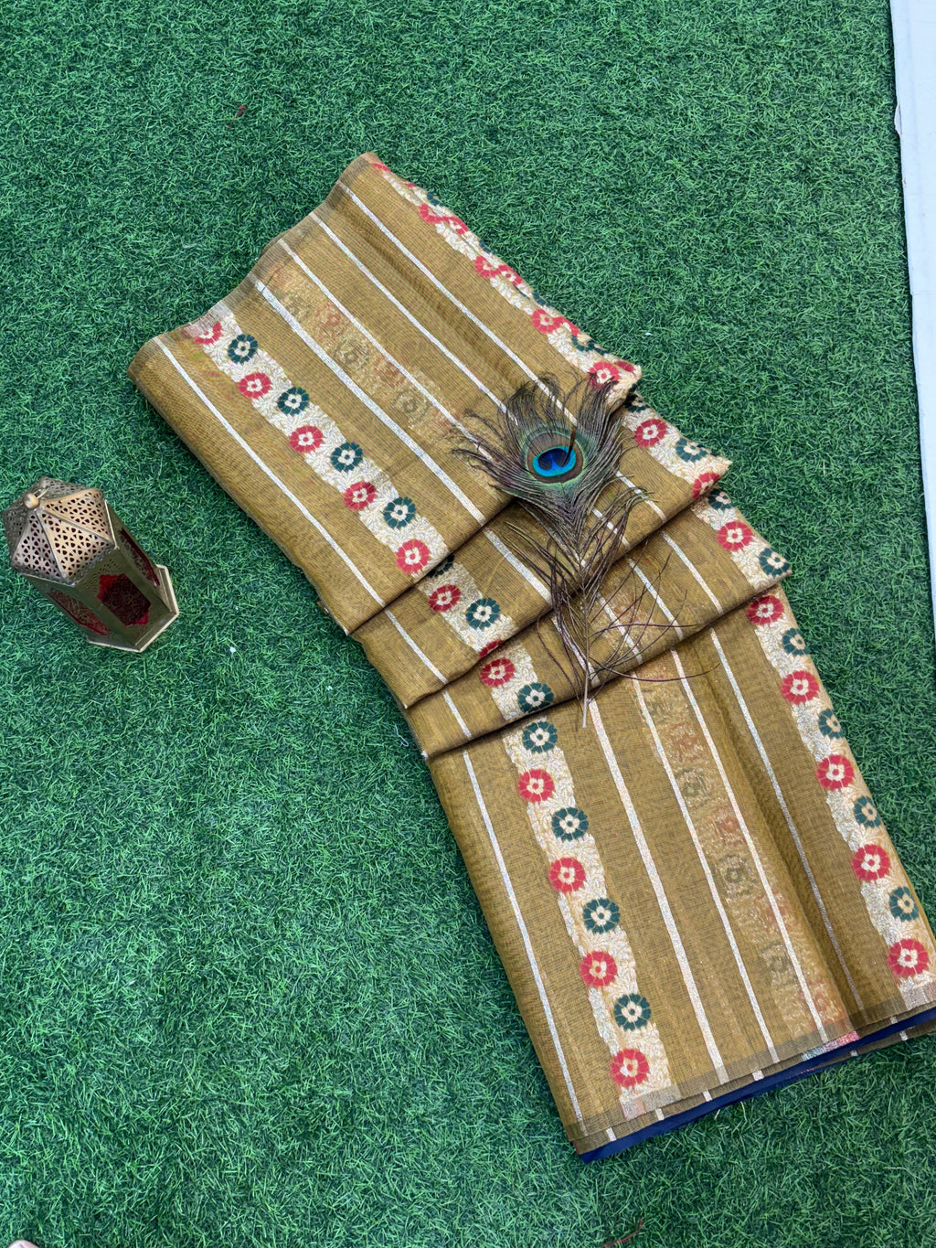 Mustard Bloom Zari Elegant soft cotton saree with fine zari stripes, multicolor floral butti bands, and a richly woven navy-blue zari pallu and border for a traditional festive appeal.