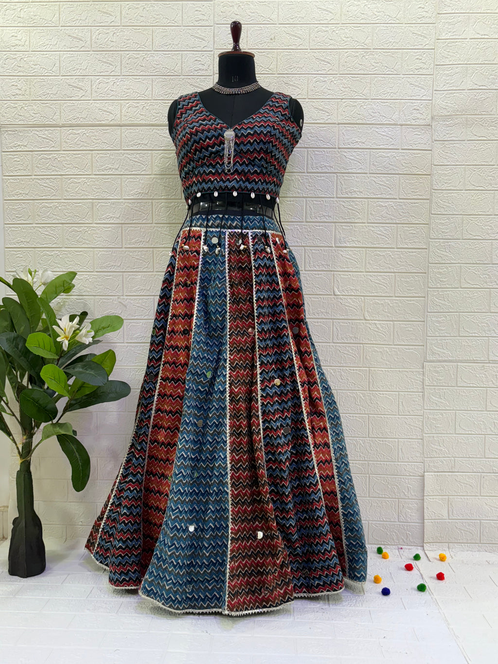 Name: Multi-Color Chevron Lehenga Set Made from lightweight pure cotton blend with chevron print panels, mirror accents, and a stitch sleeveless blouse with  cowrie shell in blouse – perfect for Navratri and festive garba nights.