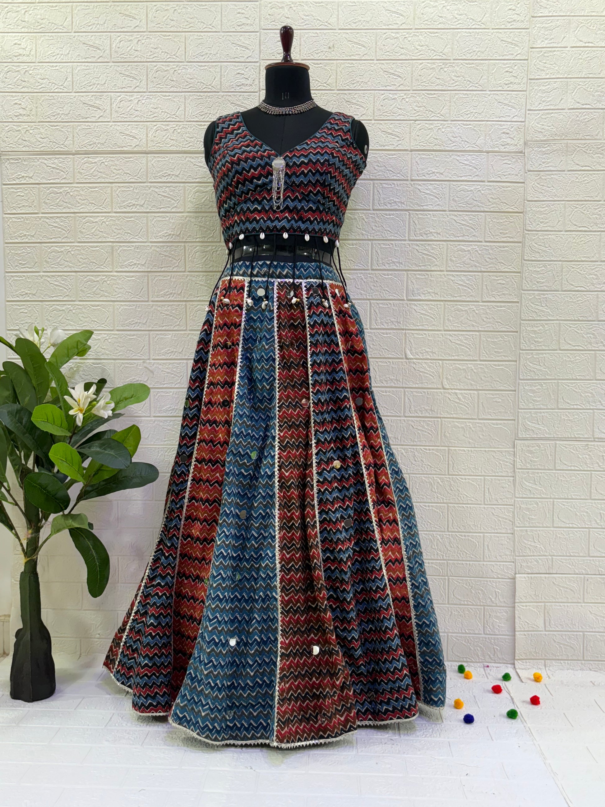 Name: Multi-Color Chevron Lehenga Set Made from lightweight pure cotton blend with chevron print panels, mirror accents, and a stitch sleeveless blouse with  cowrie shell in blouse – perfect for Navratri and festive garba nights.