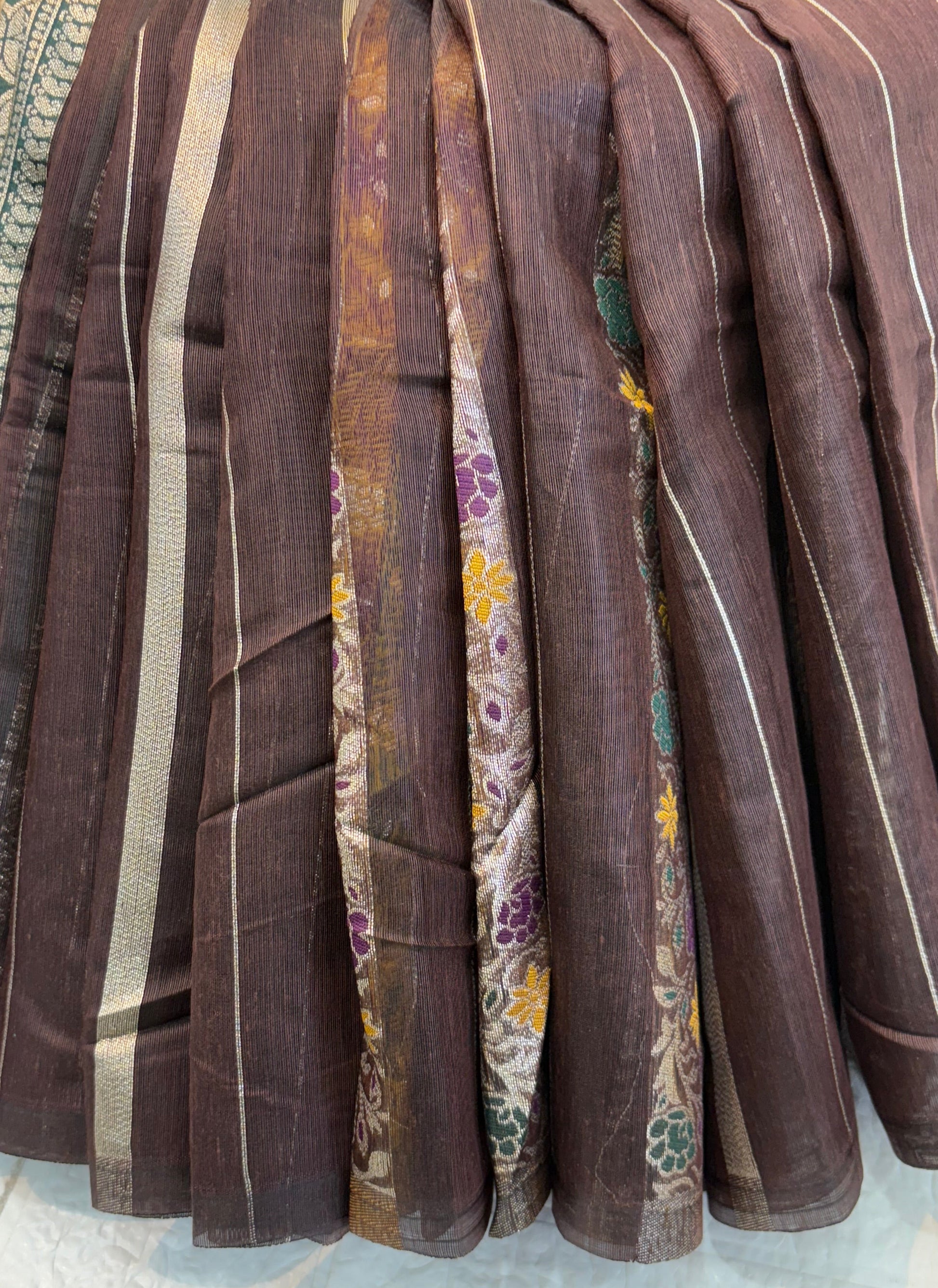 Dark brown zari Elegance Premium soft cotton saree with subtle zari stripes, floral butti accents, and a richly woven antique gold zari pallu and border for a classic, graceful look.