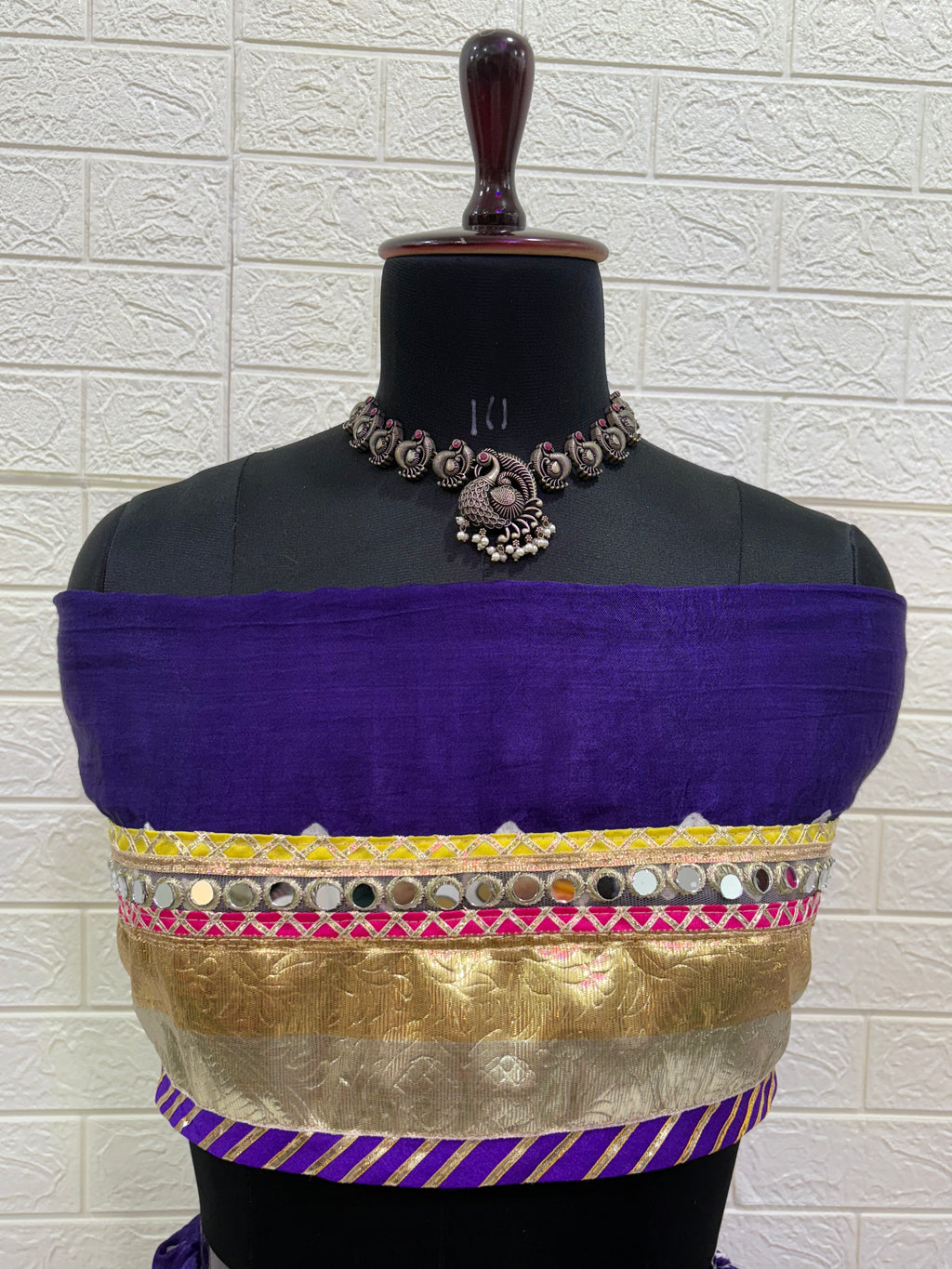 Name:
Royal Purple Bandhani Lehenga Set Made from soft synthetic satin Bandhni print with traditional paired with a contrast tie-dye dupatta and golden lace and long lumpy lace detailing for a vibrant festive look.