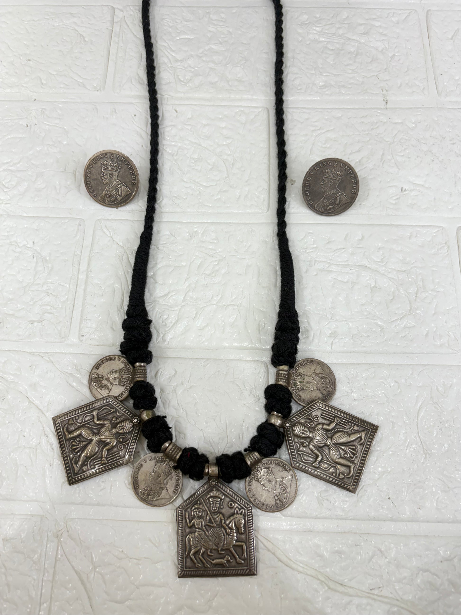 Name:
Tribal Coin Pendant Necklace Set Handcrafted oxidised silver necklace with vintage coin charms and matching earrings, perfect for adding a bold ethnic touch to festive outfits.