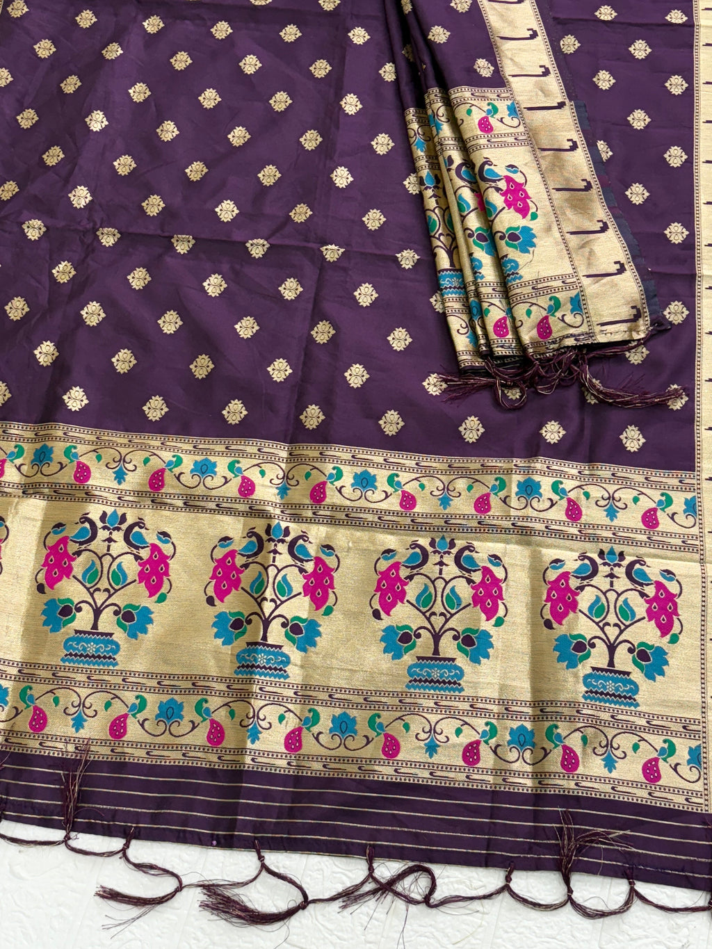 Name: Mystic Plum Banarasi Silk Dupatta 
Crafted from luxurious Banarasi silk, this dupatta features golden zari motifs all over with a contrast beige border adorned with vibrant peacock and floral patterns in teal and