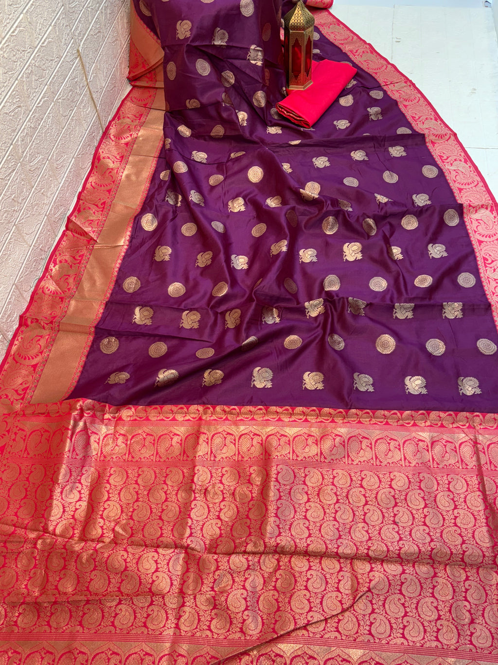 Royal Purple Zari Charm
Luxurious Banarasi silk saree adorned with elegant gold zari butti motifs and a rich contrast zari-woven border, perfect for weddings and festive occasions.