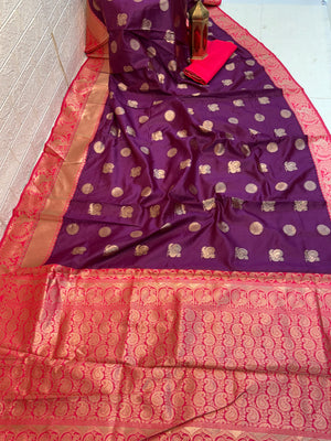 Royal Purple Zari Charm
Luxurious Banarasi silk saree adorned with elegant gold zari butti motifs and a rich contrast zari-woven border, perfect for weddings and festive occasions.