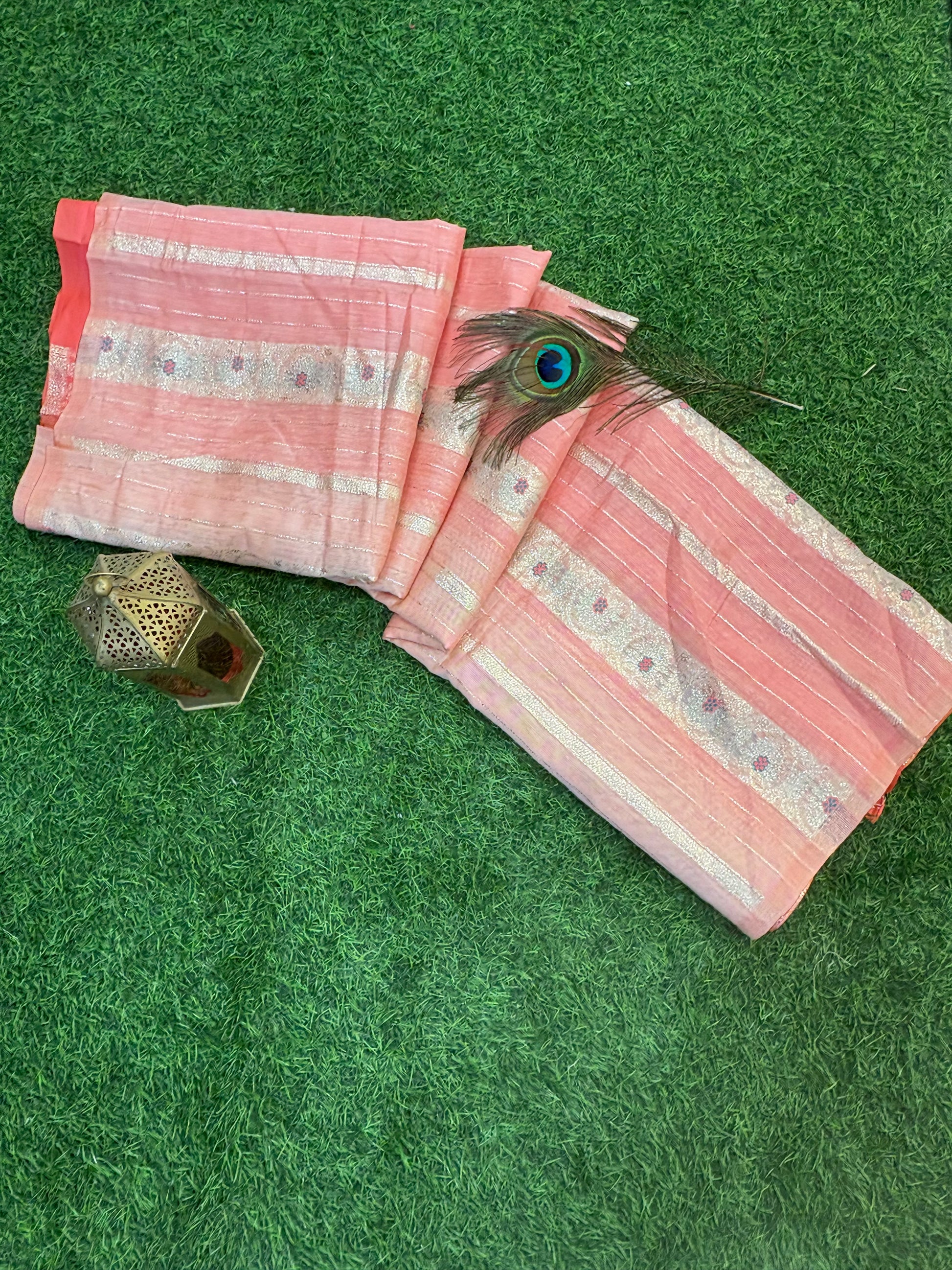 Peach Zari Grace Soft cotton saree with shimmering zari stripes, tiny floral motifs, and a rich coral-toned woven zari border for an elegant festive look.