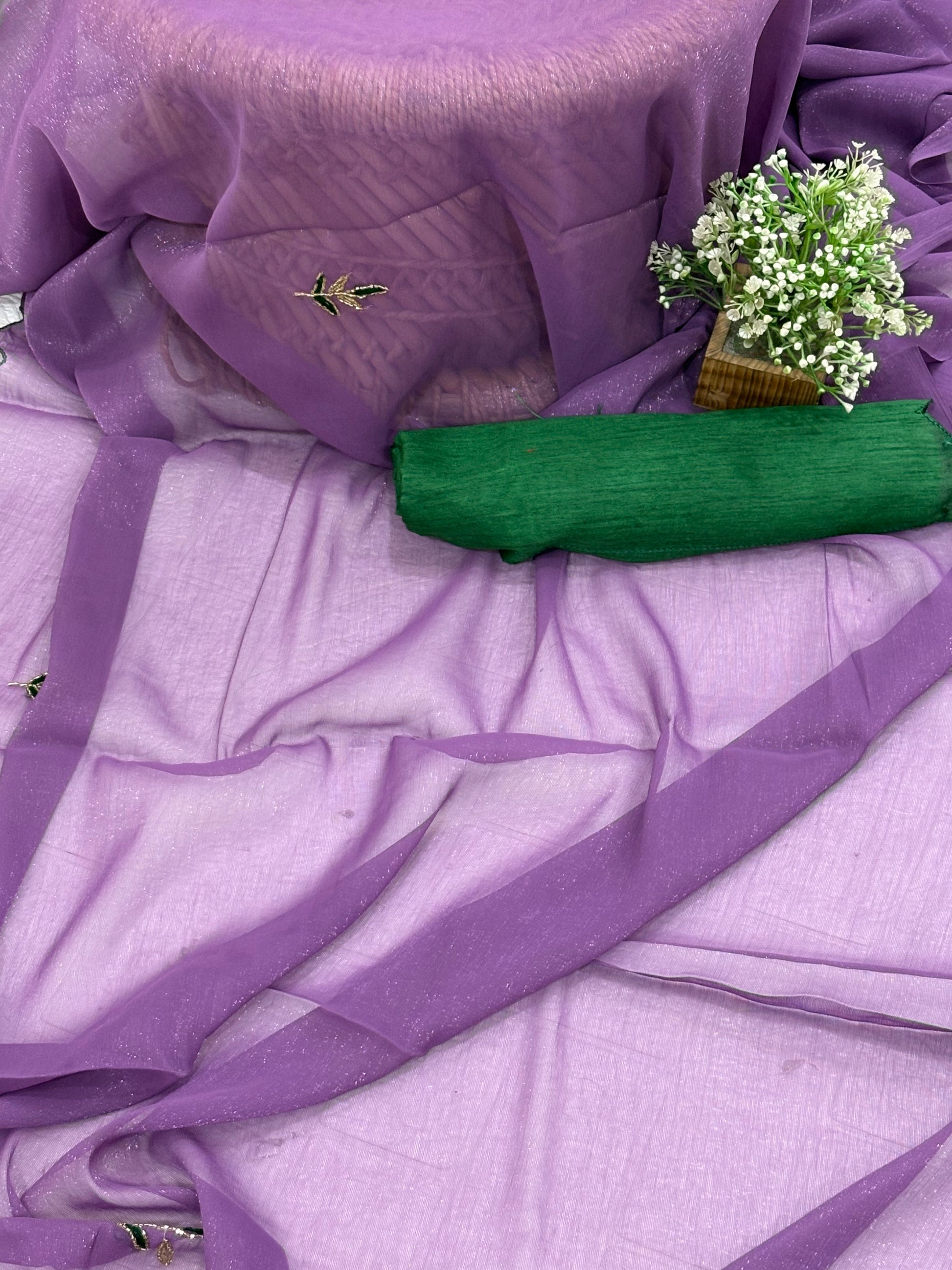 Name: Lavender Charm Ensemble Lightweight soft  shimmer organza fabric with delicate thread embroidery and shimmer detailing, paired with a Green blouse and a giving it a graceful drape