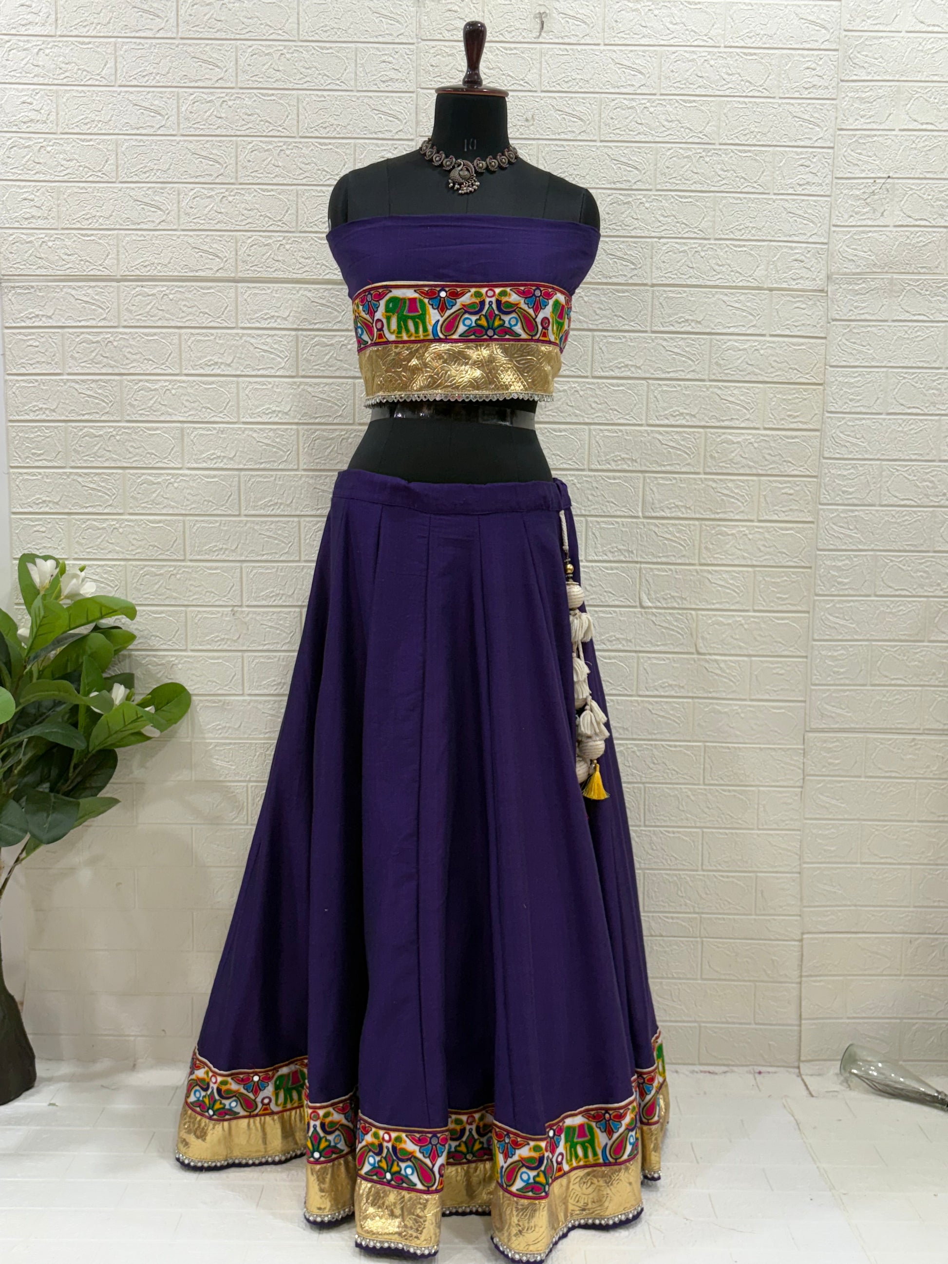 Name:
Purple Navratri Ghaghra Choli Crafted in soft cotton with a vibrant embroidered choli and colorful bandhani dupatta, this ghaghra is perfect for Garba nights and festive celebrations.