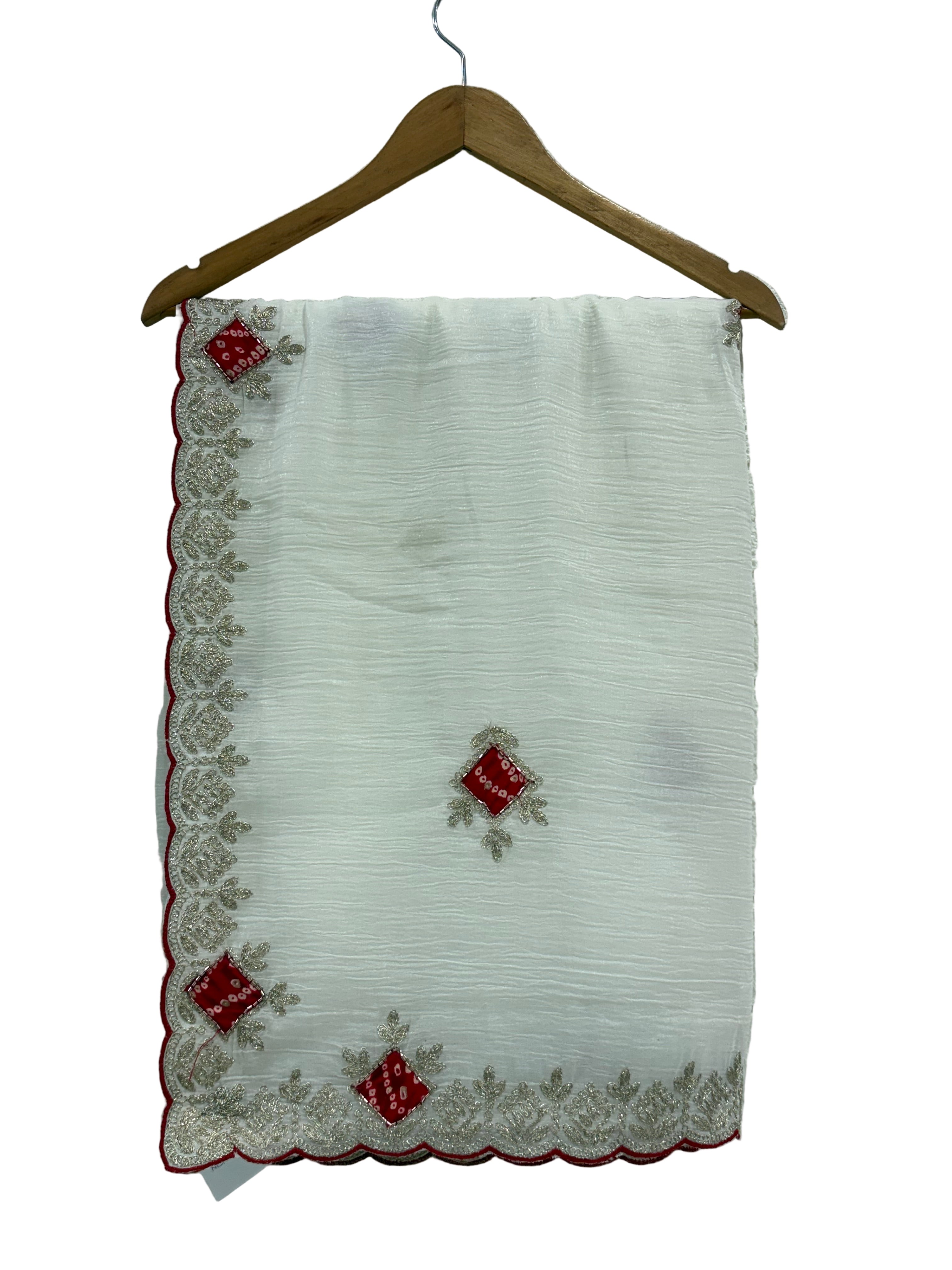 Name: Ivory Grace saree 
Elegant crush chinon fabric saree with red bandhej-style motifs and zari embroidered border. Bandhni-style blause fabric