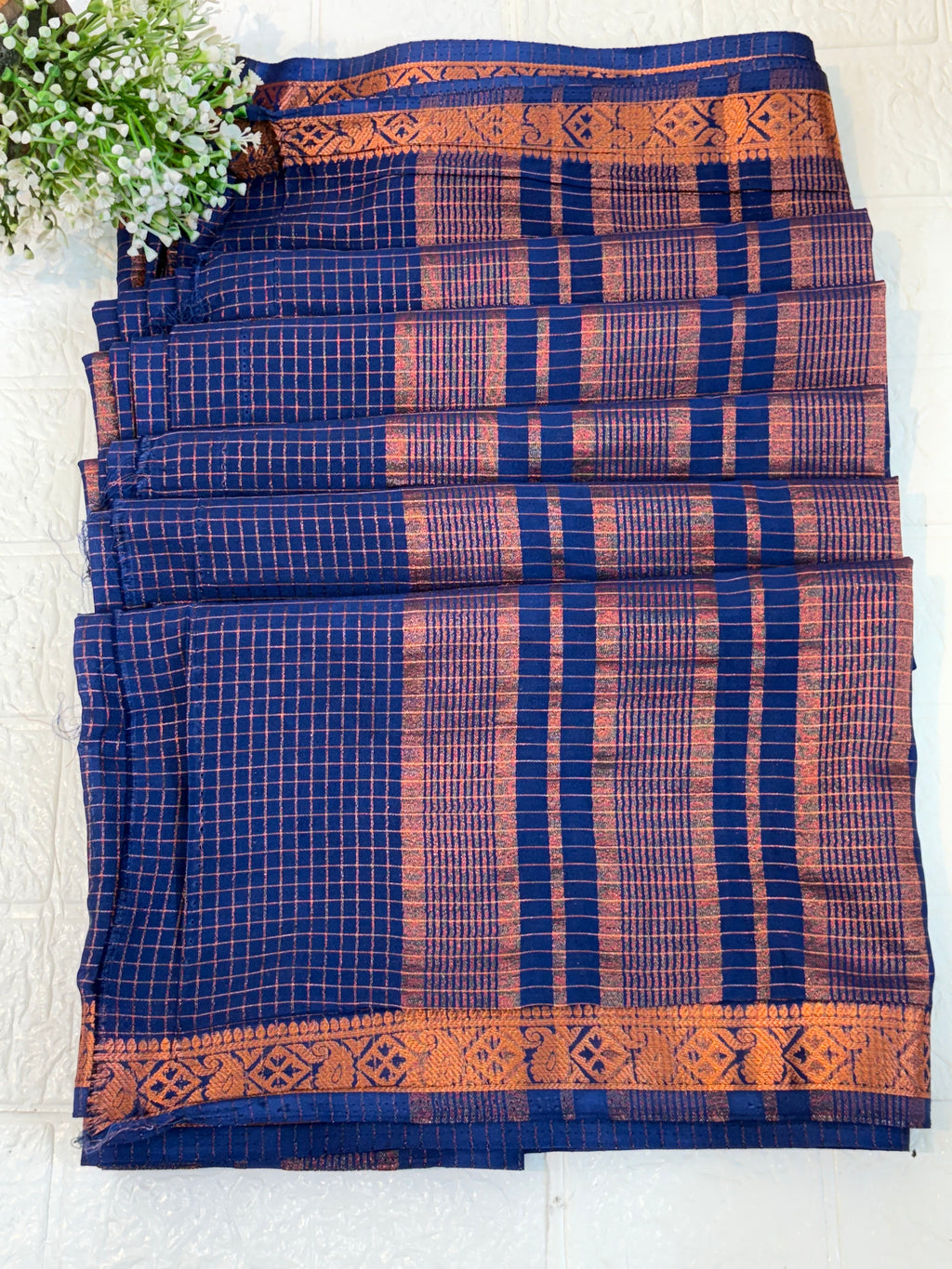 Name: Navy Blue Checkered Handloom Saree soft silk with Zari Border This saree features fine golden check patterns on a deep navy blue base, complemented by a traditional zari-woven border, giving it a rich and elegant handloom appeal.