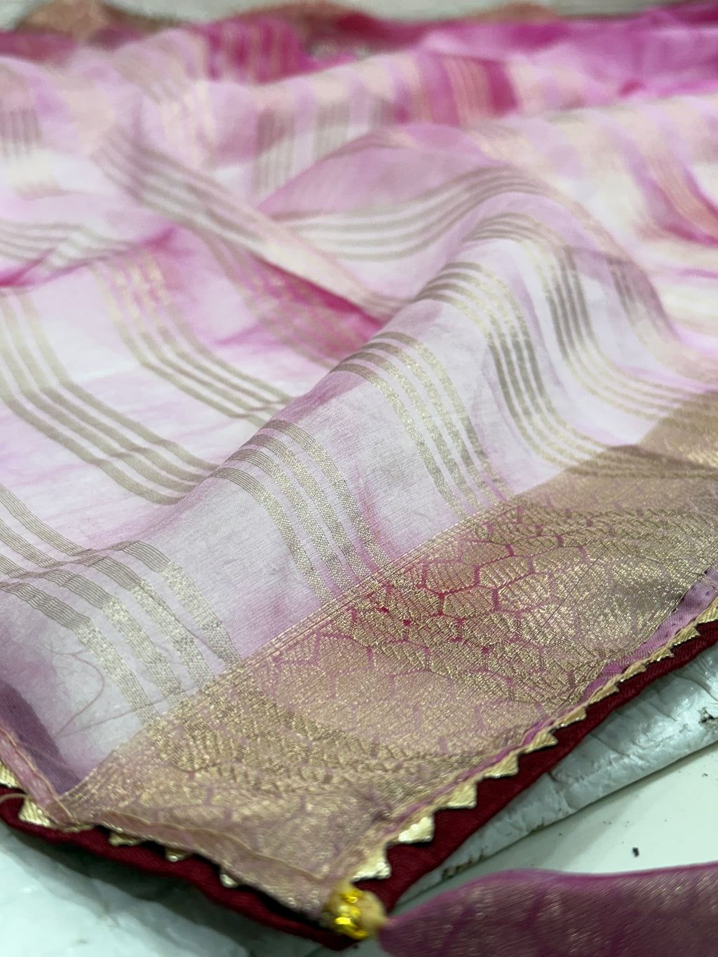 Name: Pink Ombre Organza Saree Soft organza with zari-woven golden border and delicate sequin floral embroidery, giving a graceful festive look.