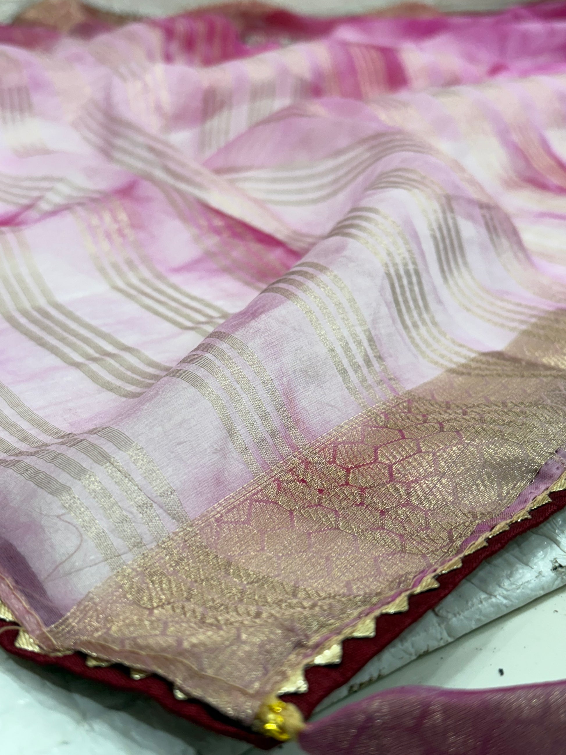 Name: Pink Ombre Organza Saree Soft organza with zari-woven golden border and delicate sequin floral embroidery, giving a graceful festive look.