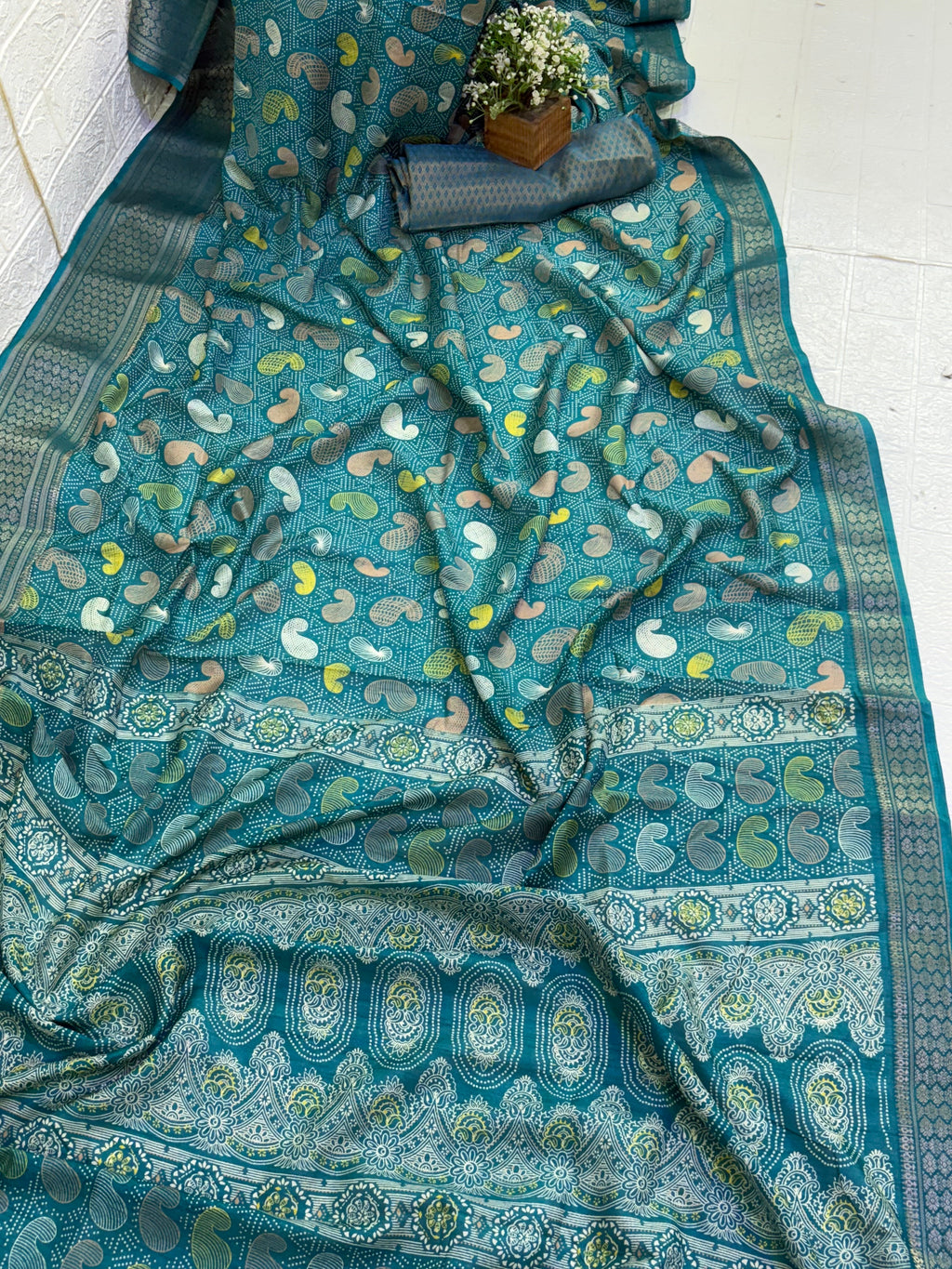 Name: Teal colour Saree
Fabric: cotton silk featuring intricate zari weaves and multicolor paisley motifs, blending tradition with elegance.