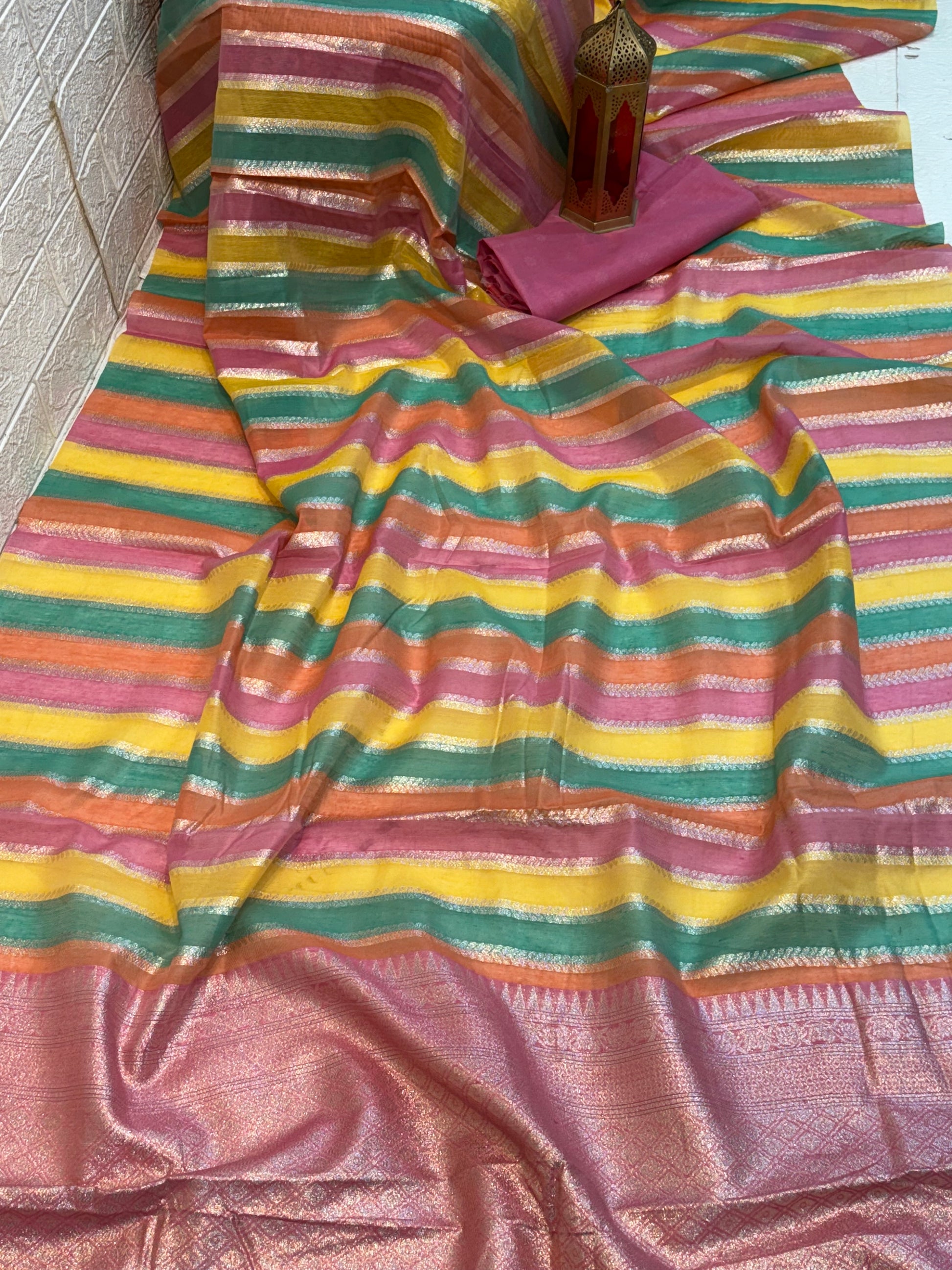 Rainbow Pastel Zari Stripe
Lightweight soft cotton saree with vibrant multicolor zari stripes and a soft pink richly woven zari border, perfect for festive and daytime occasions.