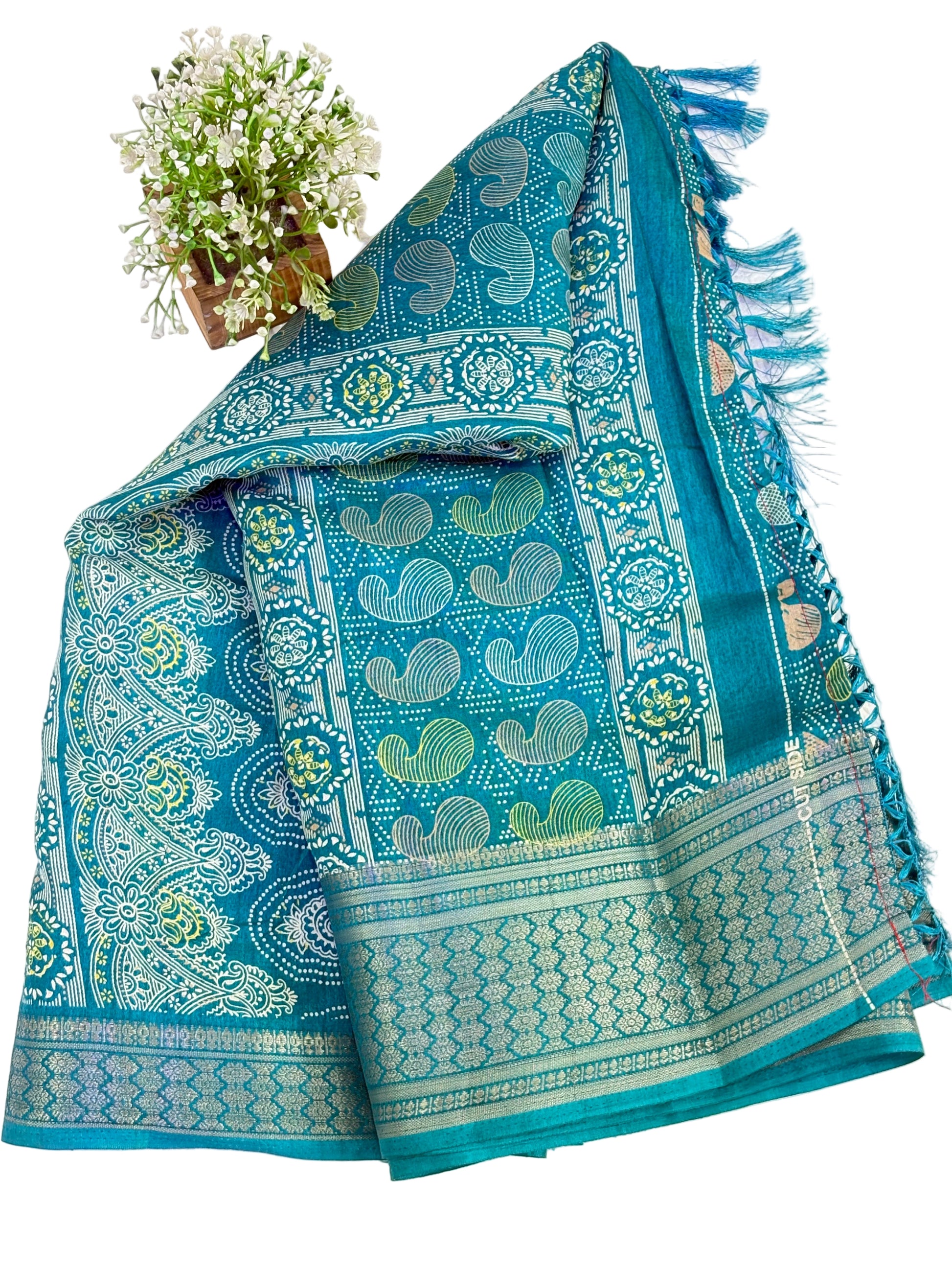 Name: Teal colour Saree
Fabric: cotton silk featuring intricate zari weaves and multicolor paisley motifs, blending tradition with elegance.