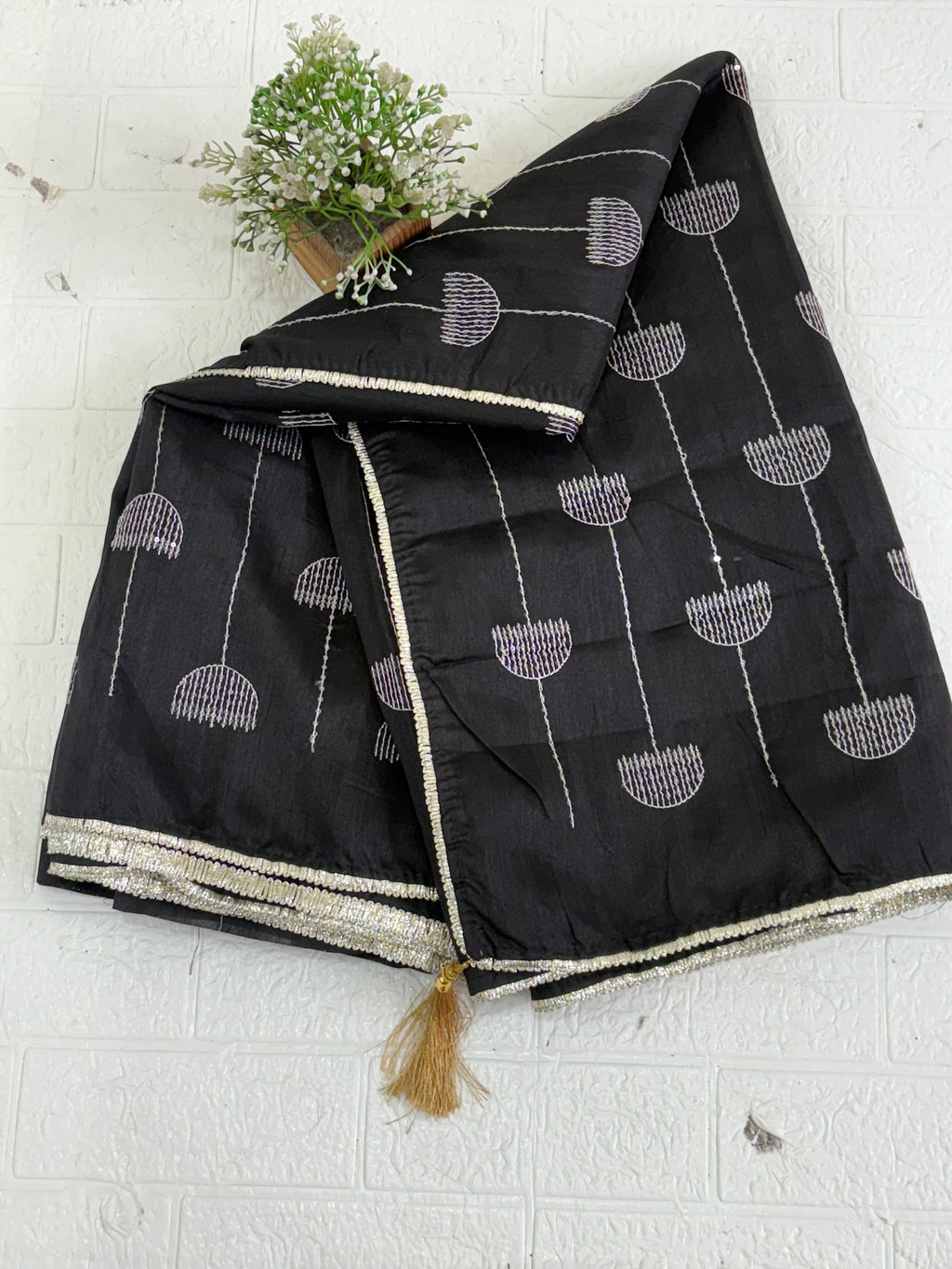 Name: Chanderi or Cotton Silk Saree The texture and slight sheen indicate a Chanderi or Cotton Silk Blend. With blouse The design features woven Zari lines/stripes and small thread/Aari embroidery motifs.