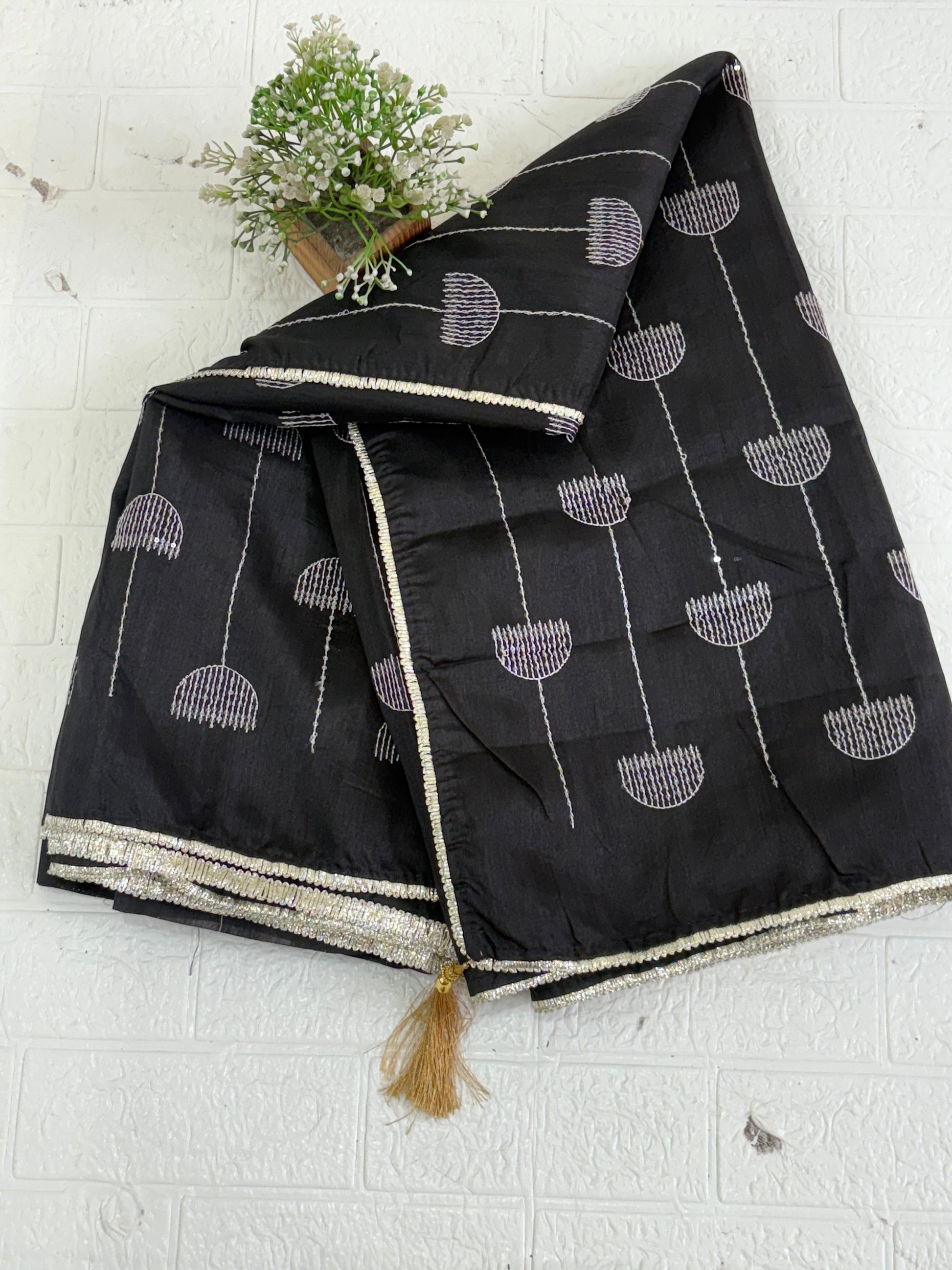 Name: Chanderi or Cotton Silk Saree The texture and slight sheen indicate a Chanderi or Cotton Silk Blend. With blouse The design features woven Zari lines/stripes and small thread/Aari embroidery motifs.
