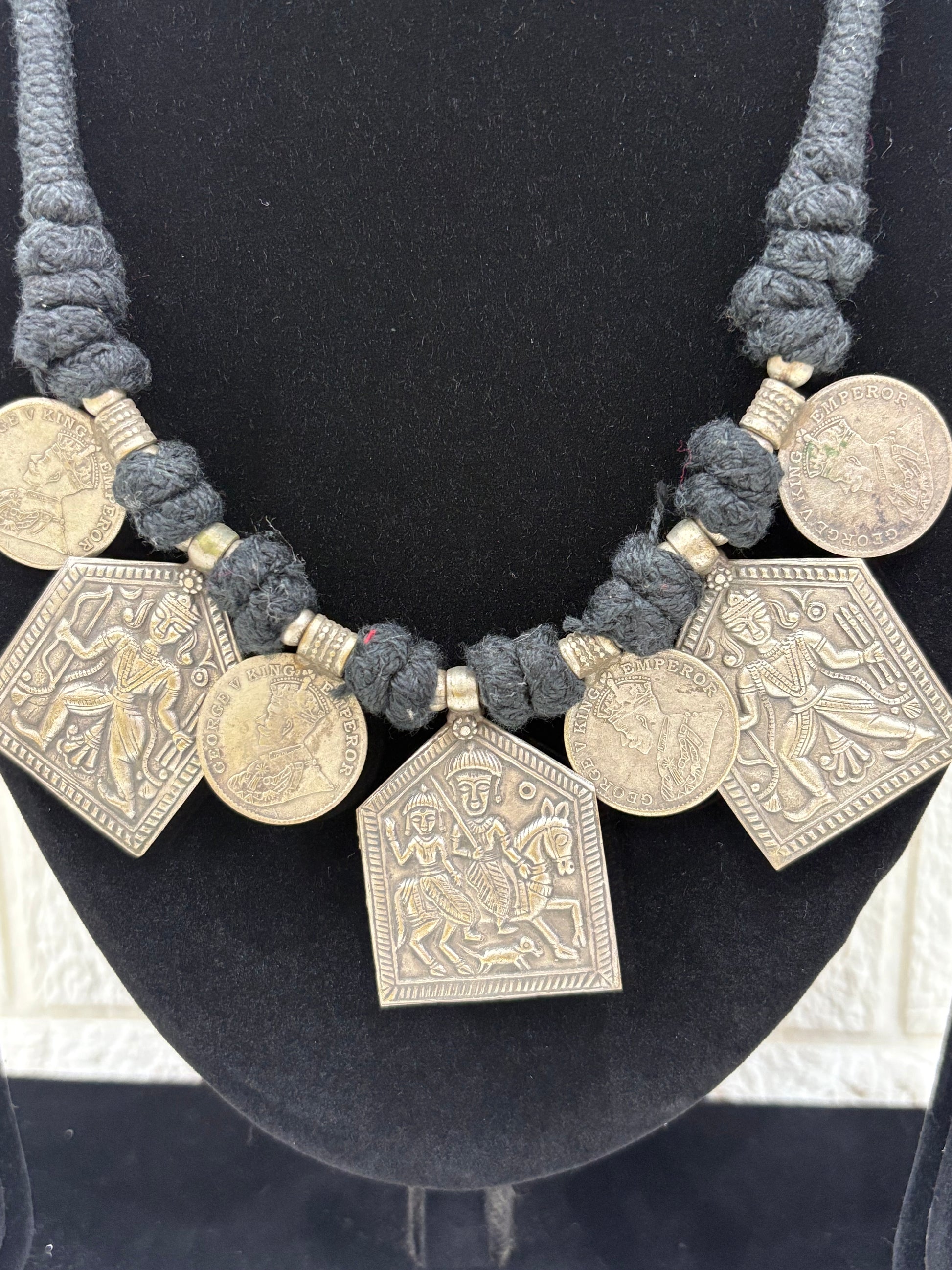 Name:
Tribal Coin Pendant Necklace Set Handcrafted oxidised silver necklace with vintage coin charms and matching earrings, perfect for adding a bold ethnic touch to festive outfits.