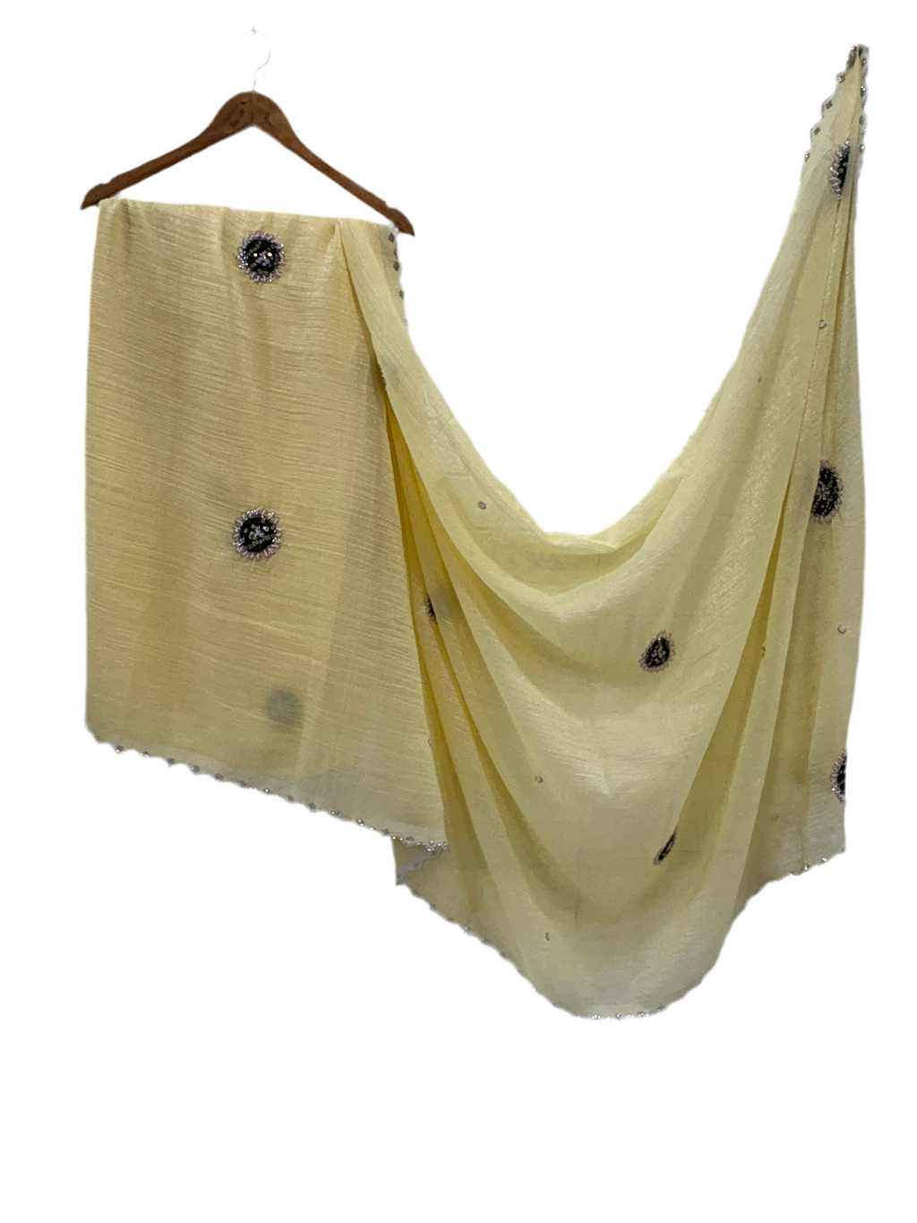 Light yellow crepe Saree with a sheer, lightweight fabric forest green Bandhani print blouse base embellished with sequins and embroidery butas.