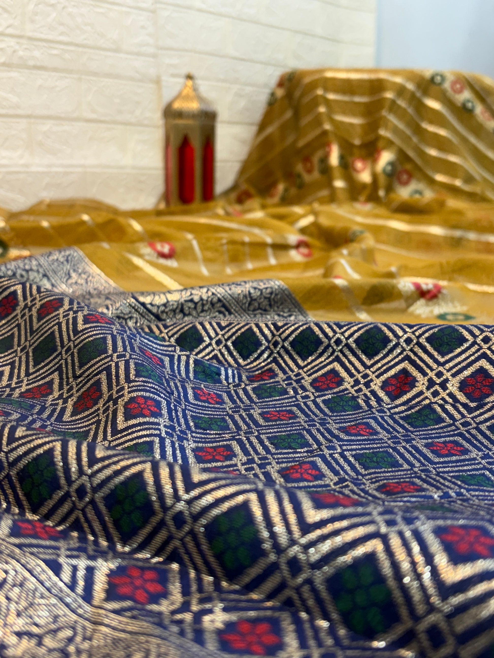 Mustard Bloom Zari Elegant soft cotton saree with fine zari stripes, multicolor floral butti bands, and a richly woven navy-blue zari pallu and border for a traditional festive appeal.