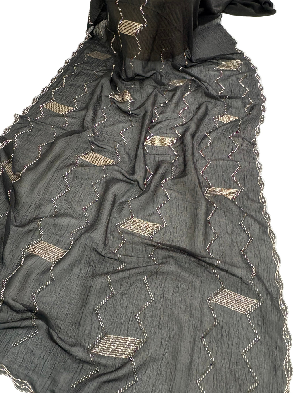 Name: Black Zigzag Embroidered Saree
Fabric: Lightweight crepe georgette with metallic thread embroidery