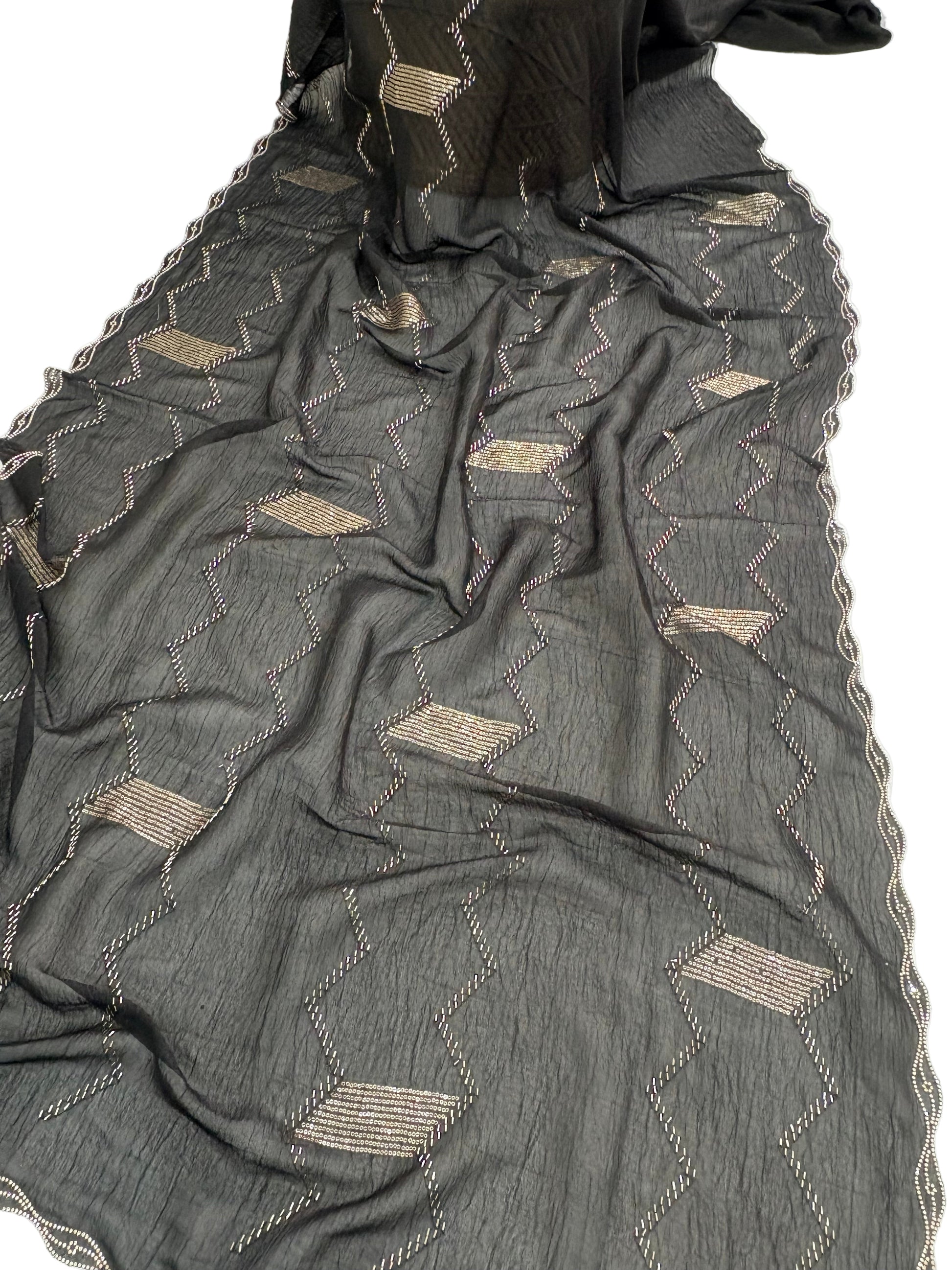 Name: Black Zigzag Embroidered Saree
Fabric: Lightweight crepe georgette with metallic thread embroidery