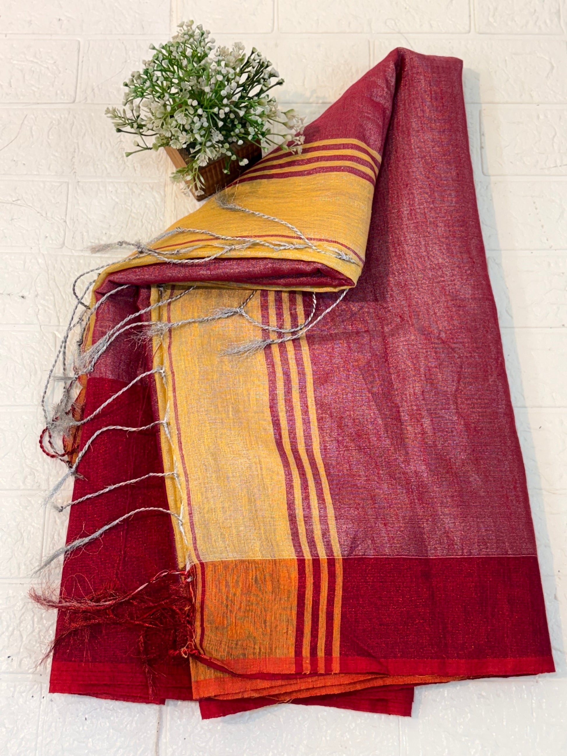 Name: Dual Shade Mustard and Maroon cotton shimmering Saree with a rich mustard body and maroon pallu, accented by a subtle border.