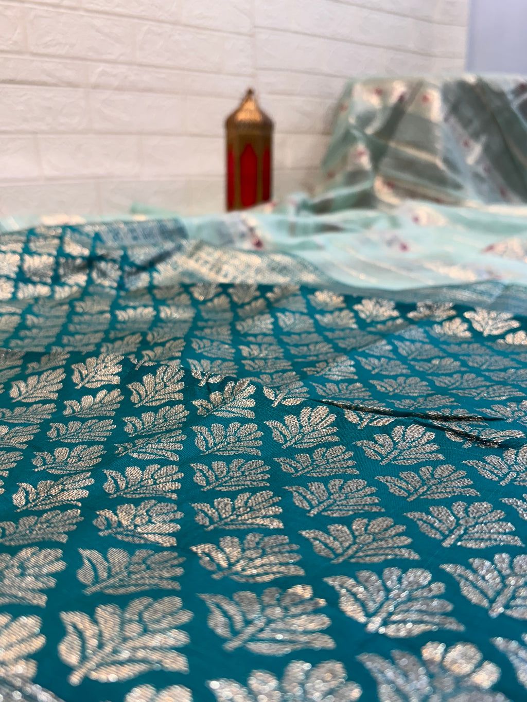 Zari Bloom Elegant sky blue soft cotton saree with soft zari stripes, delicate floral butti work, and a richly woven teal zari border for a refined festive look.