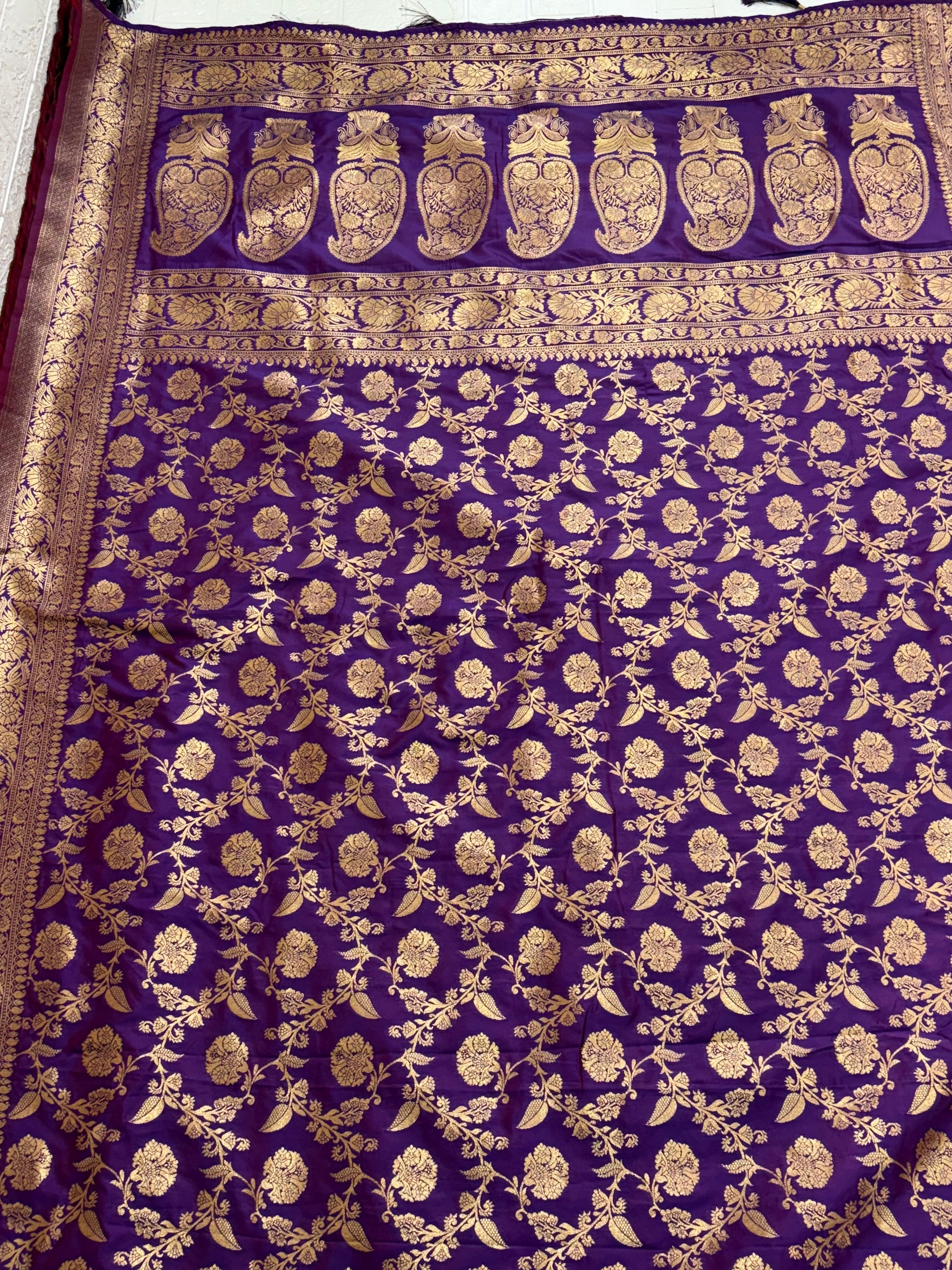 Name: Patola-Style or Kanchipuram Checked Silk Saree purple colour with golden work featuring a woven geometric check and floral zari work.