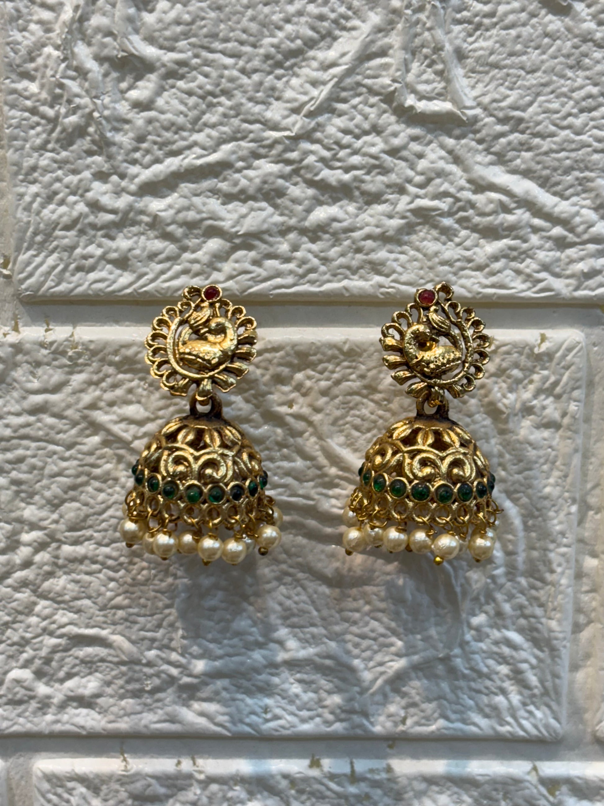Traditional long haram featuring intricate motifs with ruby-green stone detailing and pearl drop pendant, paired with classic jhumka earrings—perfect for weddings and festive occasions.