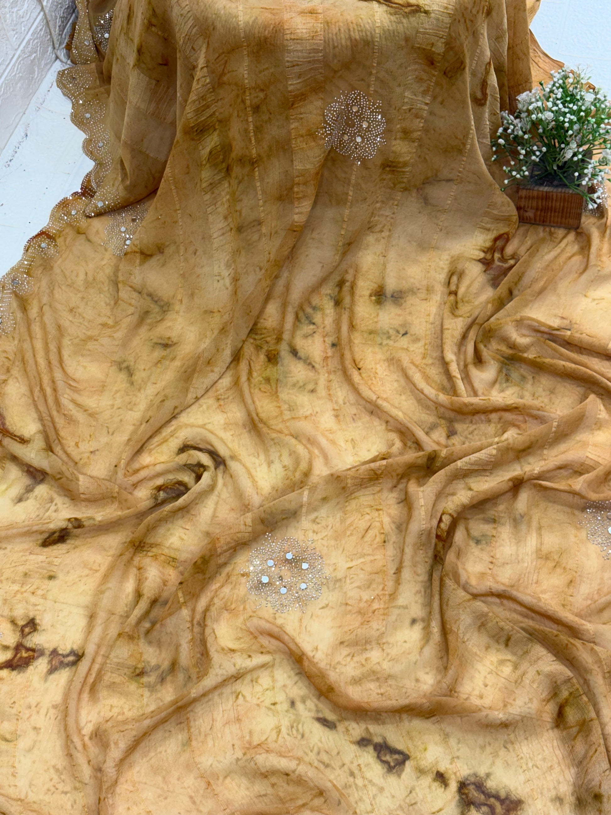 Saree with woven mirror work or light mustard and light brown colour small motif the pattern is a motif woven the sheer georgette fabric silk with mirror work in saree this fabric is known for it’s sheer lightweight texture