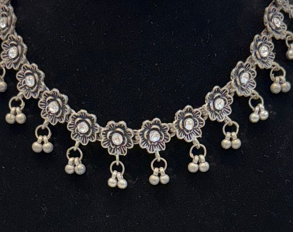 Name: Floral Oxidized Silver Necklace Set Crafted in German silver with antique finish and dangling bead accents