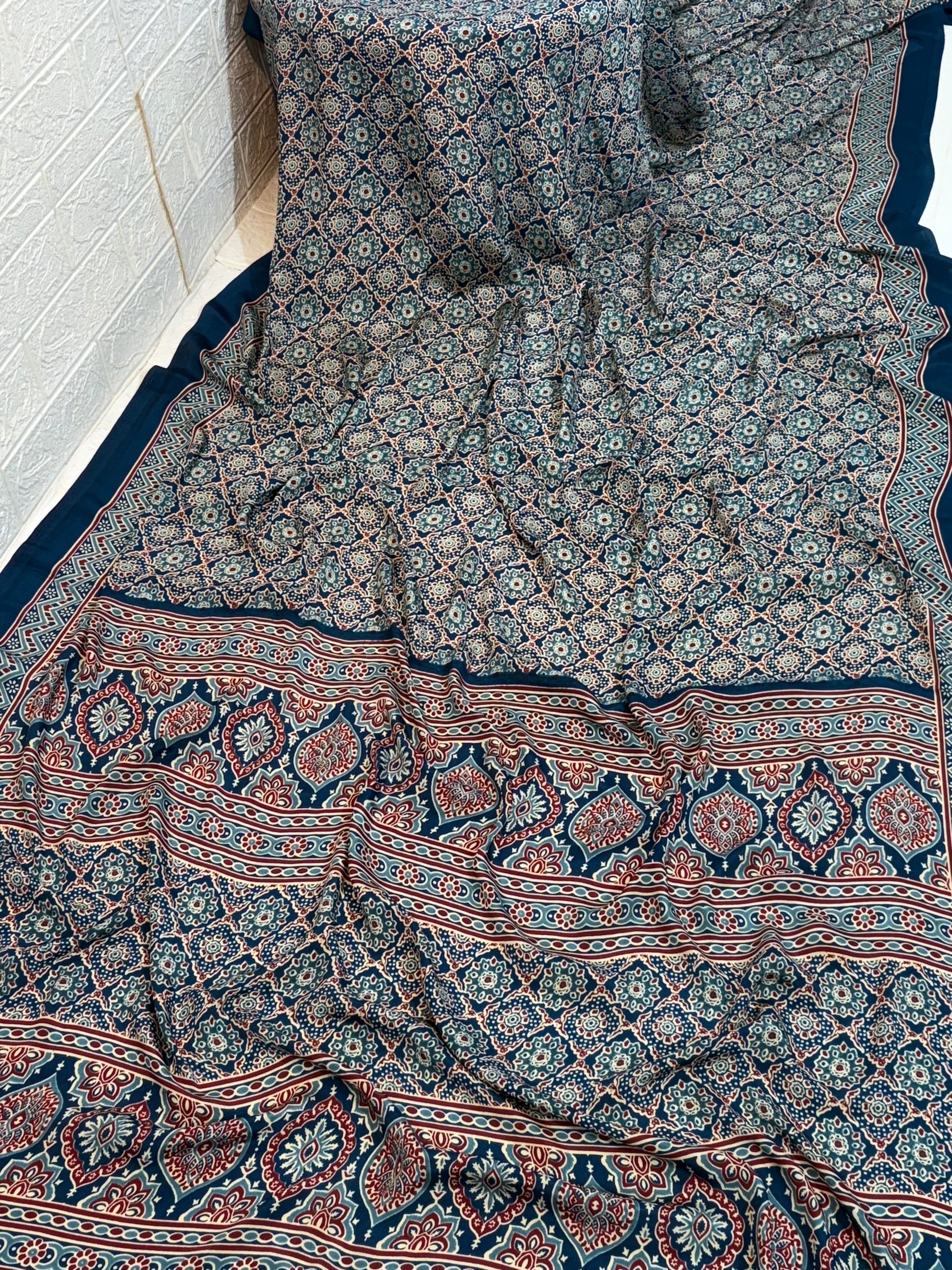 Indigo Ajrakh Motif Saree
Made from soft crepe  fabric, this saree showcases classic Ajrakh-inspired geometric prints in rich indigo tones, offering breathable comfort with a timeless handcrafted look.