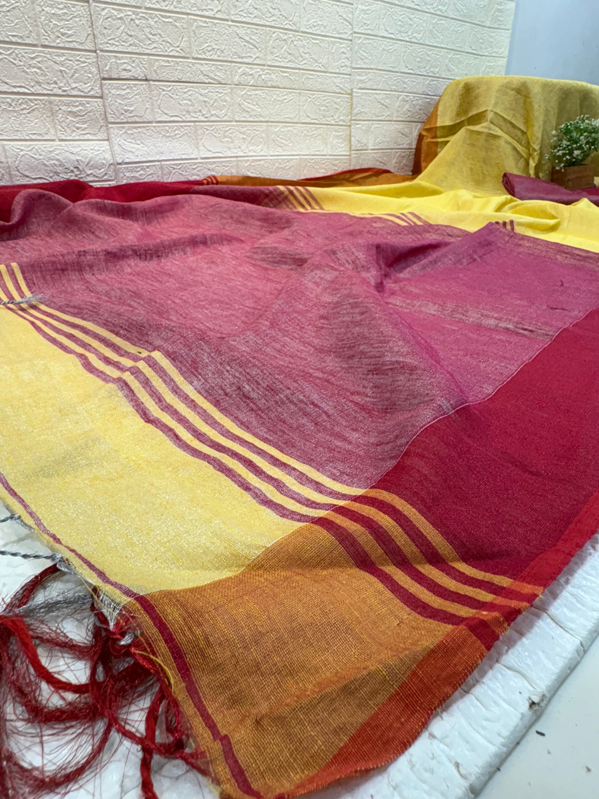 Name: Dual Shade Mustard and Maroon cotton shimmering Saree with a rich mustard body and maroon pallu, accented by a subtle border.