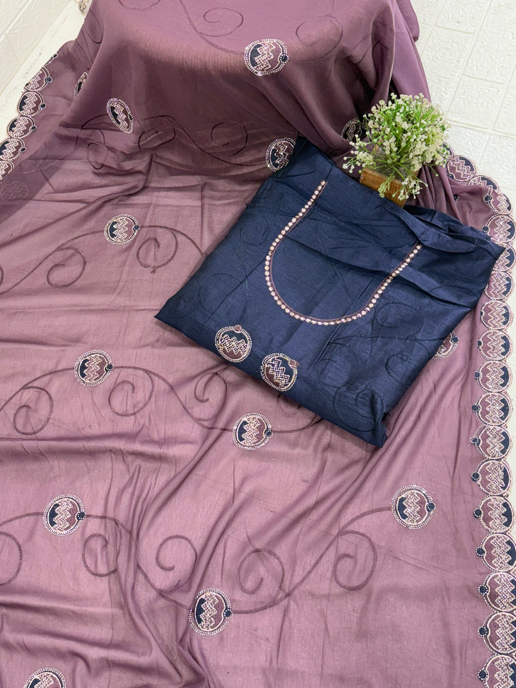 Saree Purple Embroidered Saree with purple mauve and georgette or organza Medallion Butti and Scalloped Border. It is a sheer saree with scattered embroidery and stonework.