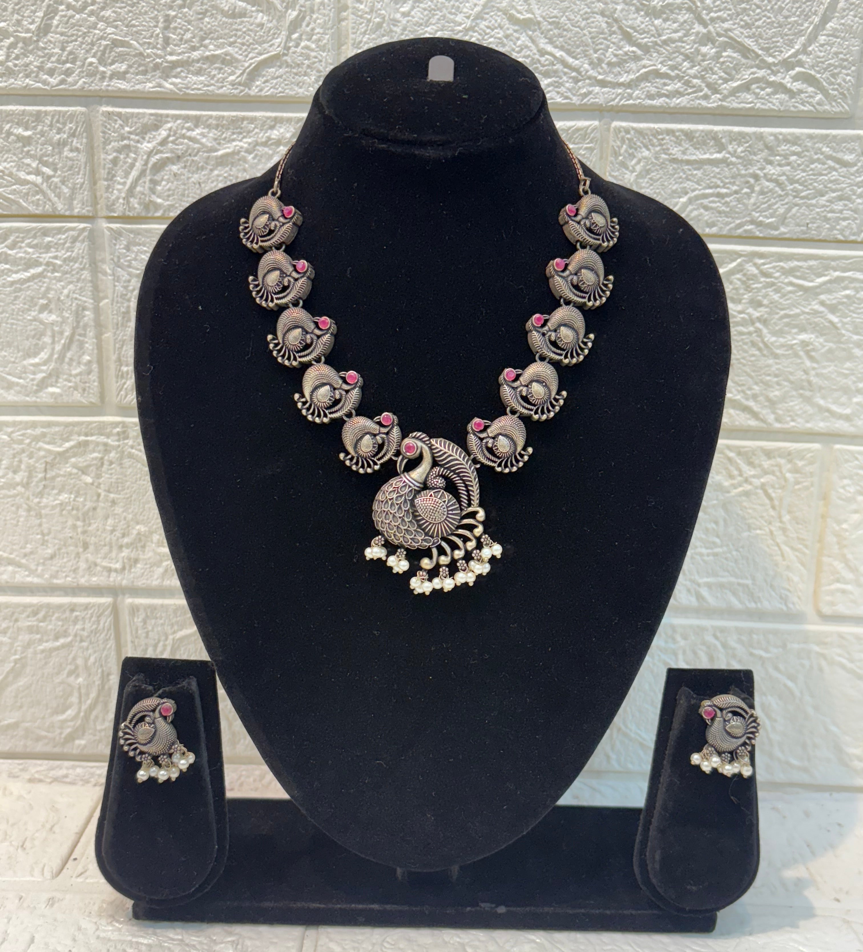 Name: Antique Peacock Oxidized Necklace Set German silver with pink ruby stone accents and pearl bead embellishments