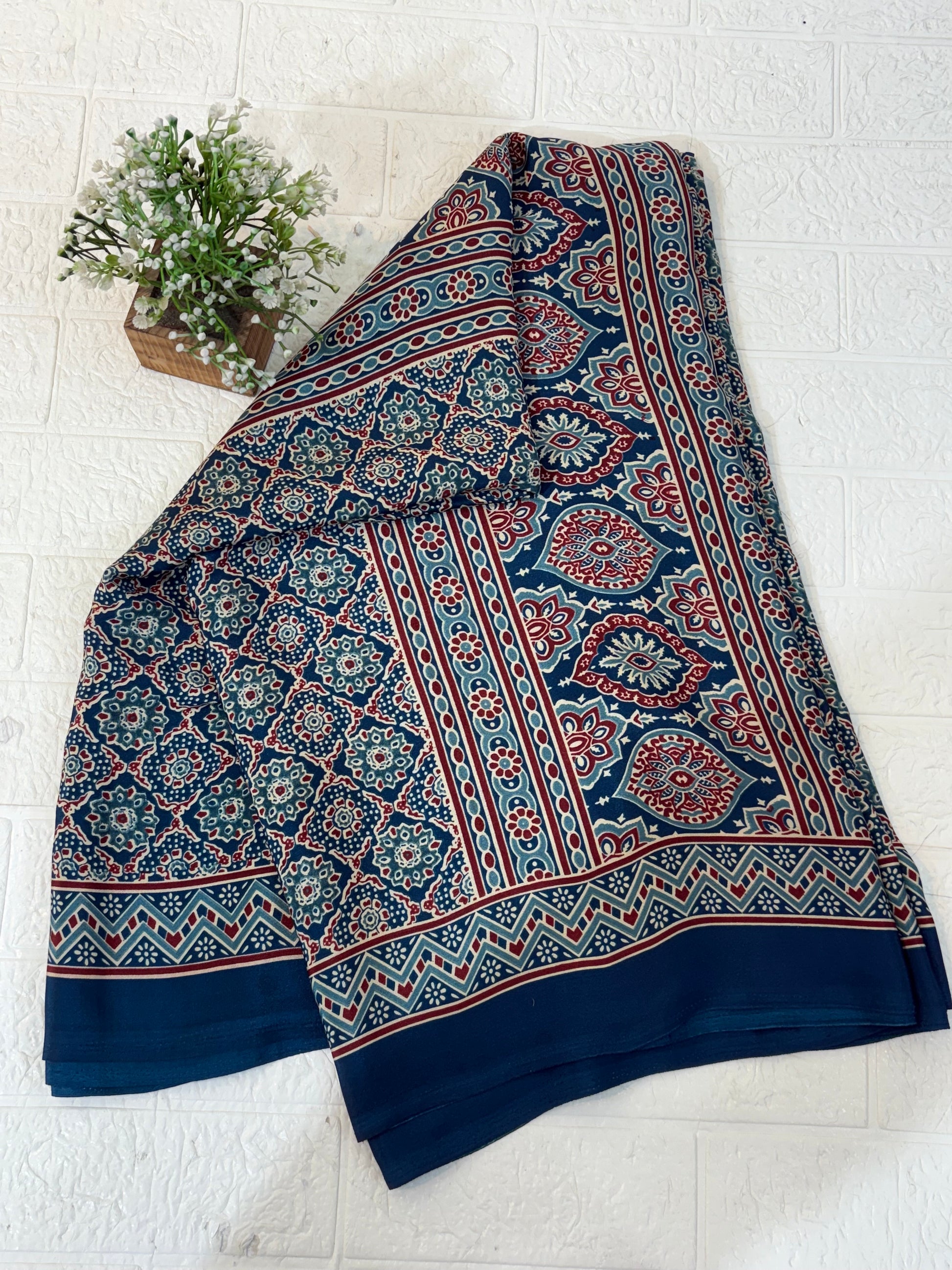 Indigo Ajrakh Motif Saree
Made from soft crepe  fabric, this saree showcases classic Ajrakh-inspired geometric prints in rich indigo tones, offering breathable comfort with a timeless handcrafted look.
