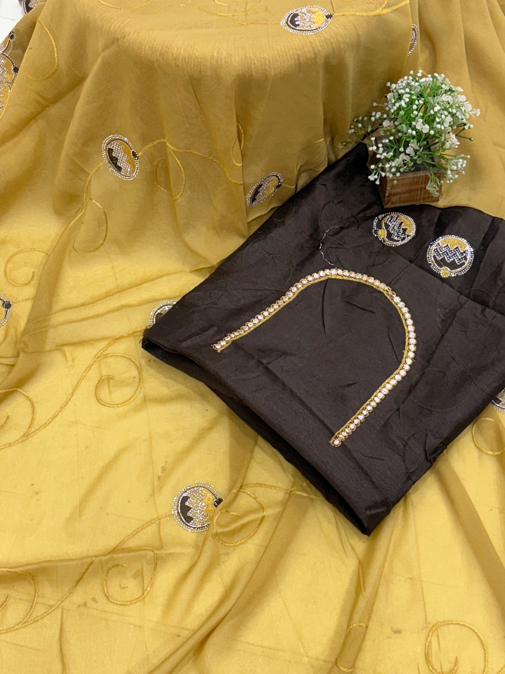 Saree georgette or organza and mustard colour Embroidered Medallion butti and Saree with Scalloped Border it is a sheer saree with scattered embroider and stonework