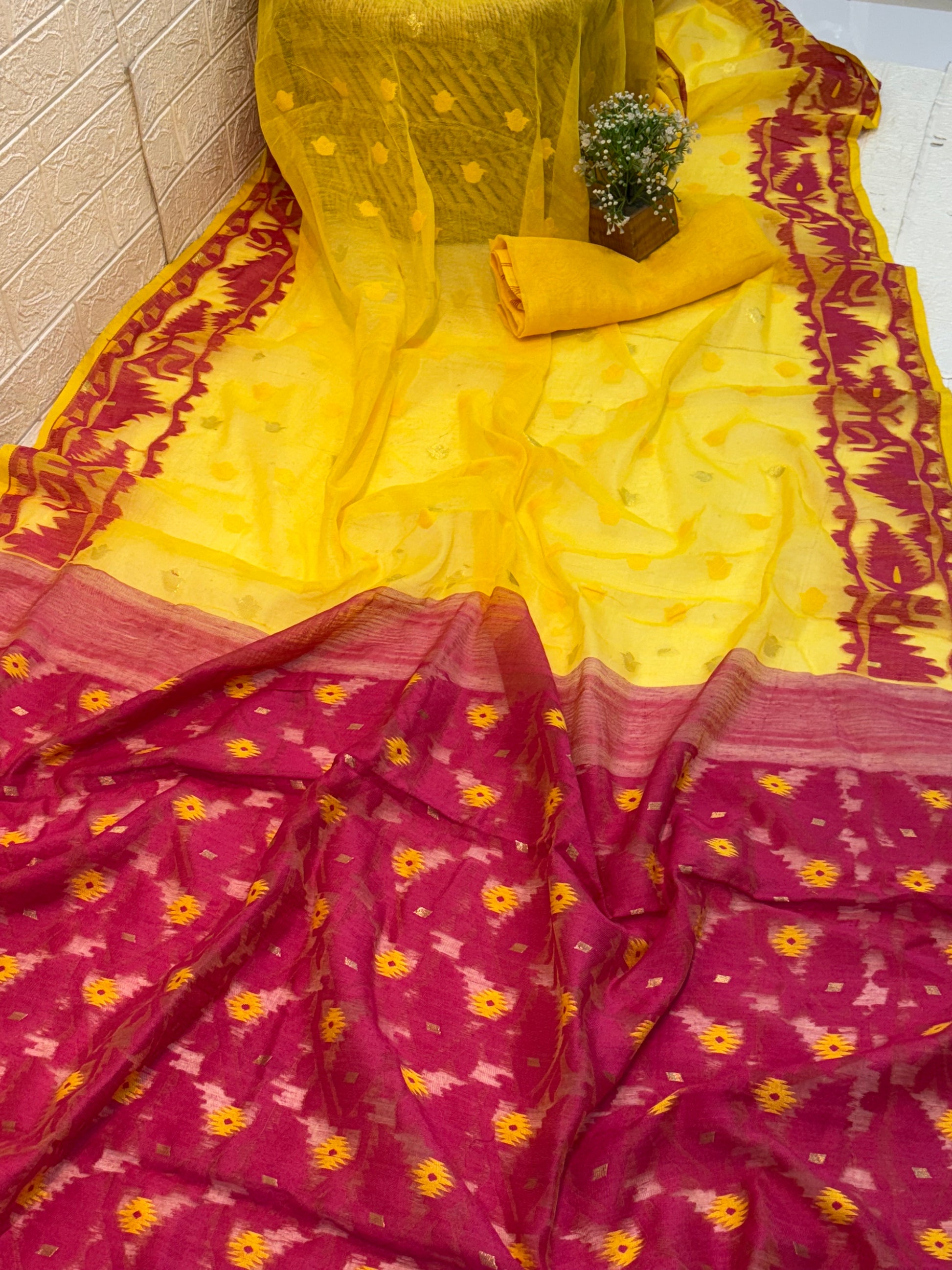 Sunrise Magenta Jamdani Saree cotton Jamdani, featuring a bright yellow body with magenta contrast border and delicate handwoven motifs, light and airy in feel.