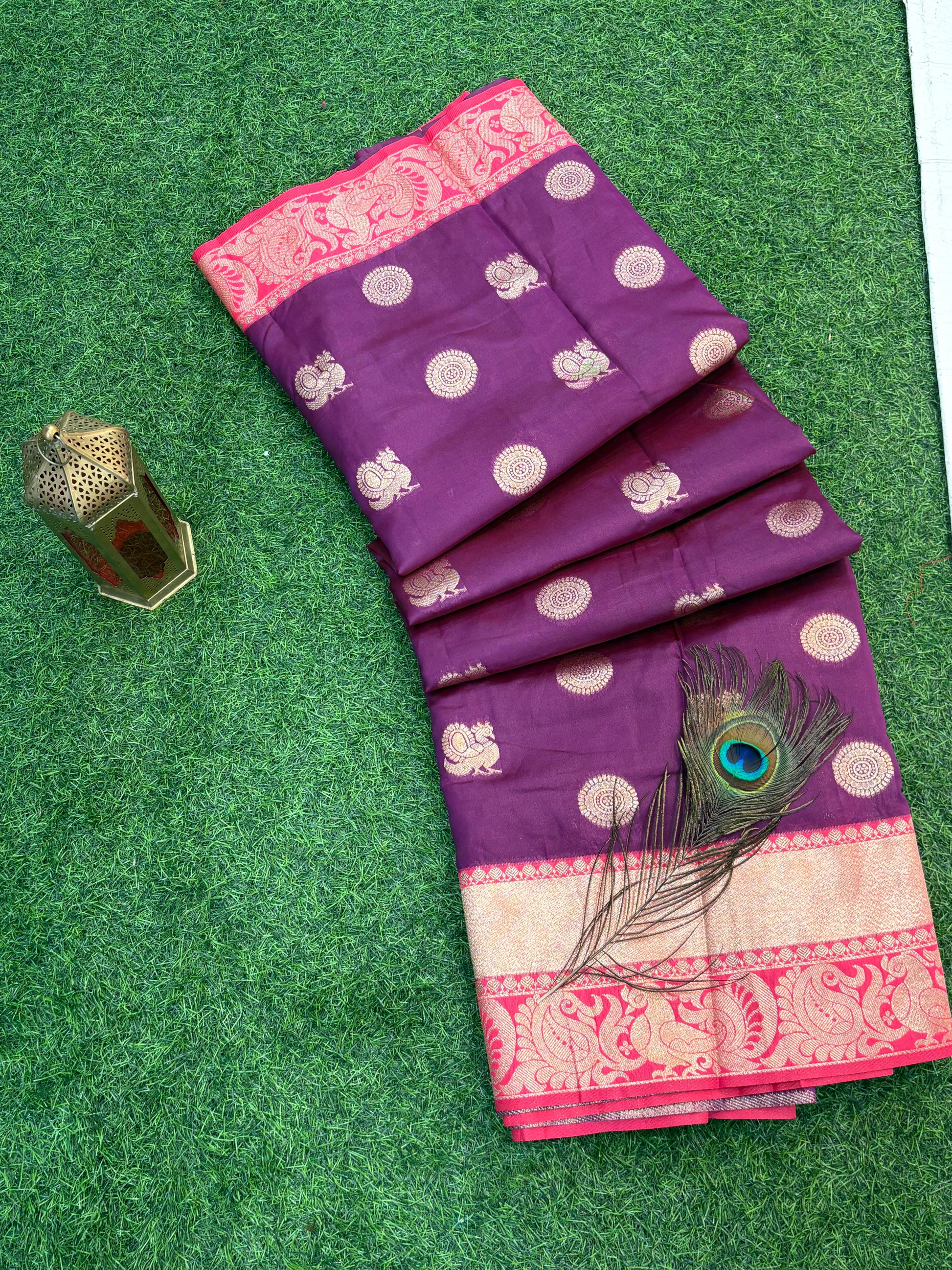 Royal Purple Zari Charm
Luxurious Banarasi silk saree adorned with elegant gold zari butti motifs and a rich contrast zari-woven border, perfect for weddings and festive occasions.