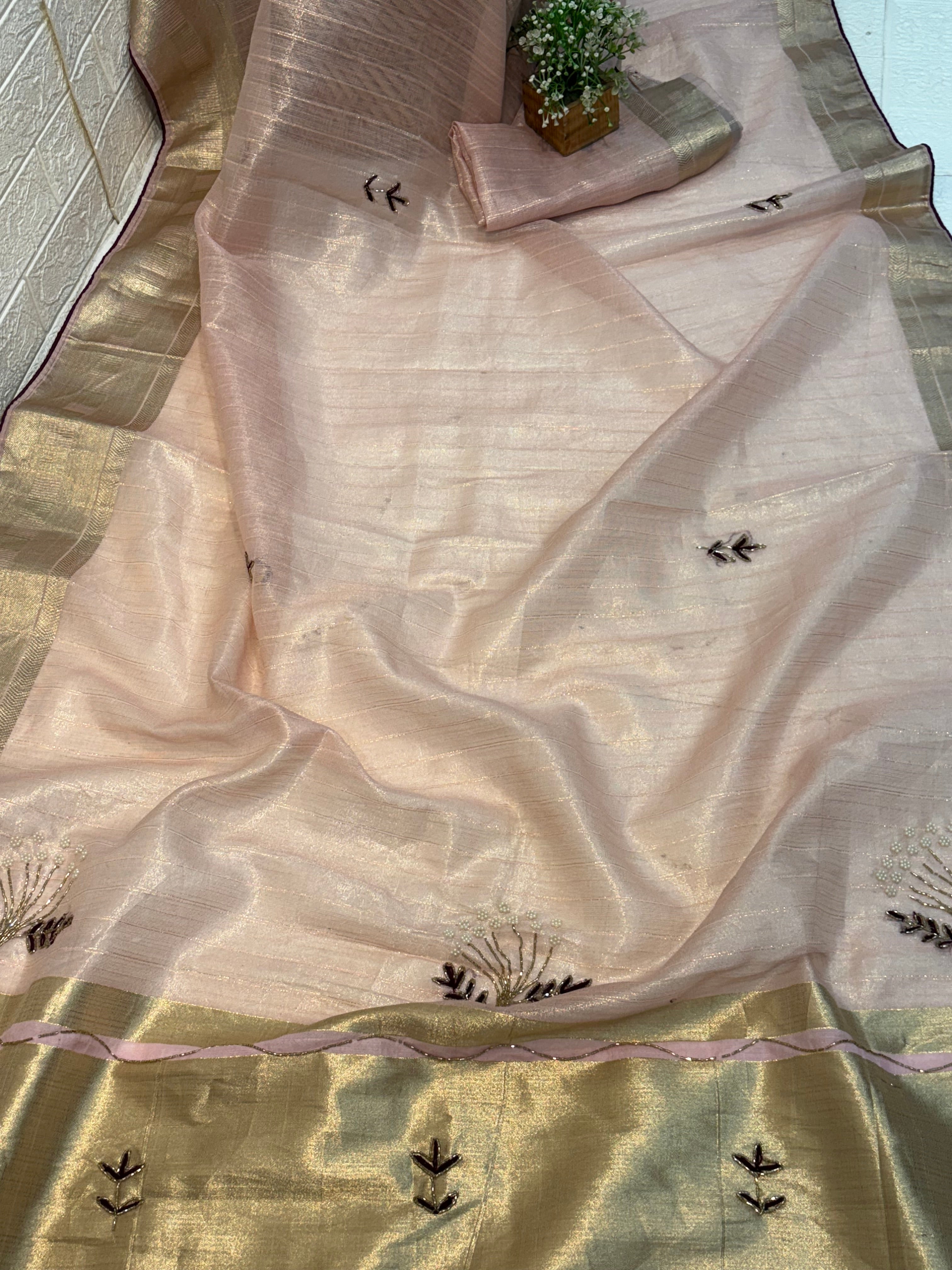 Name: Soft Pastel Pink cotton  shimmering tissue silk fabric 
with delicate zari border and subtle hand-embroidered motifs