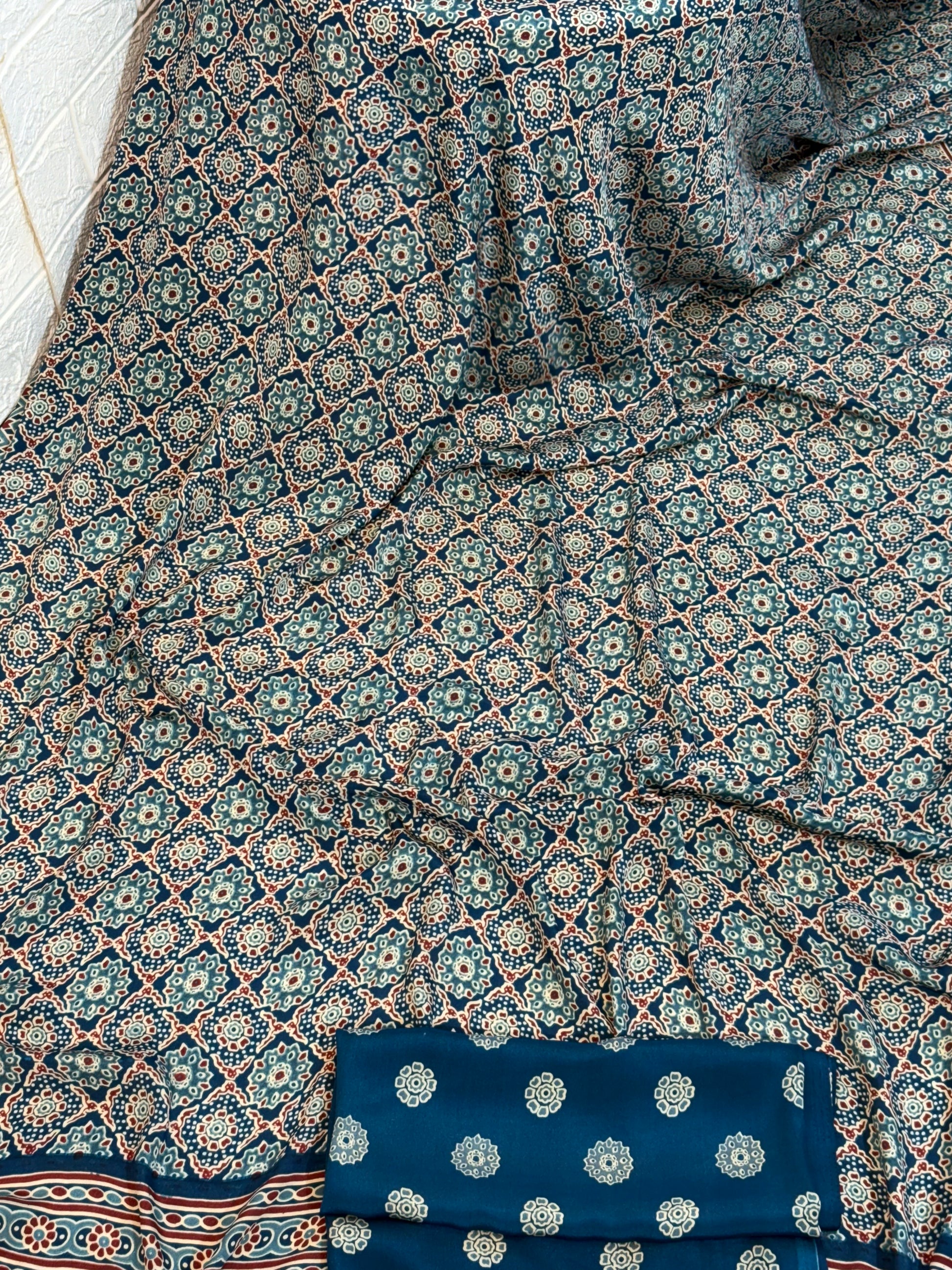 Indigo Ajrakh Motif Saree
Made from soft crepe  fabric, this saree showcases classic Ajrakh-inspired geometric prints in rich indigo tones, offering breathable comfort with a timeless handcrafted look.