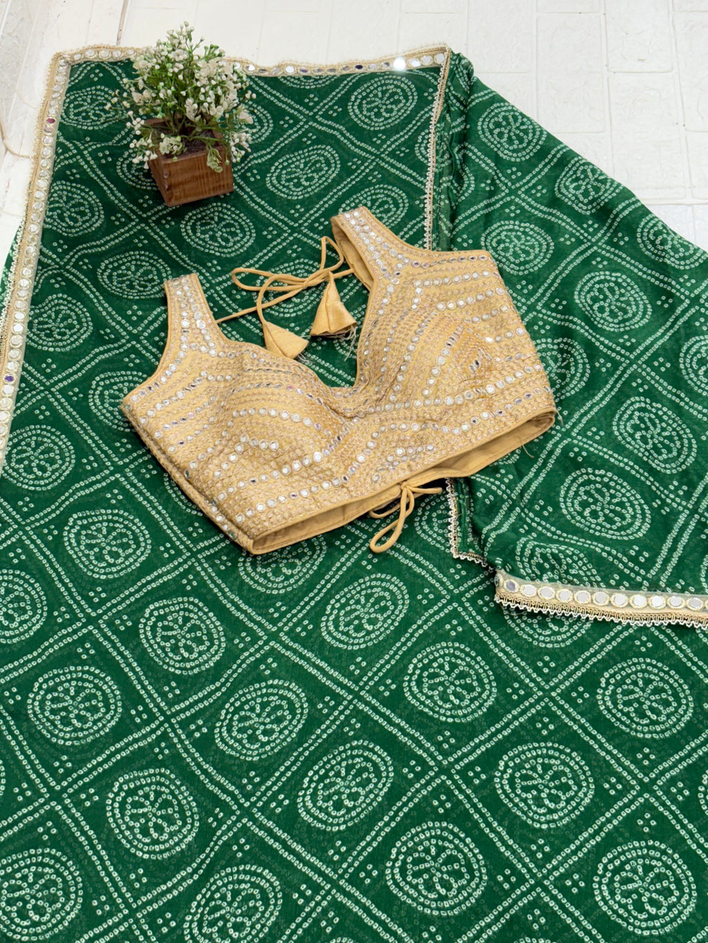 Bandhani Print Fabric crepe Silk Blend with traditional tie-dye pattern and mirror-work golden blouse embellishment.