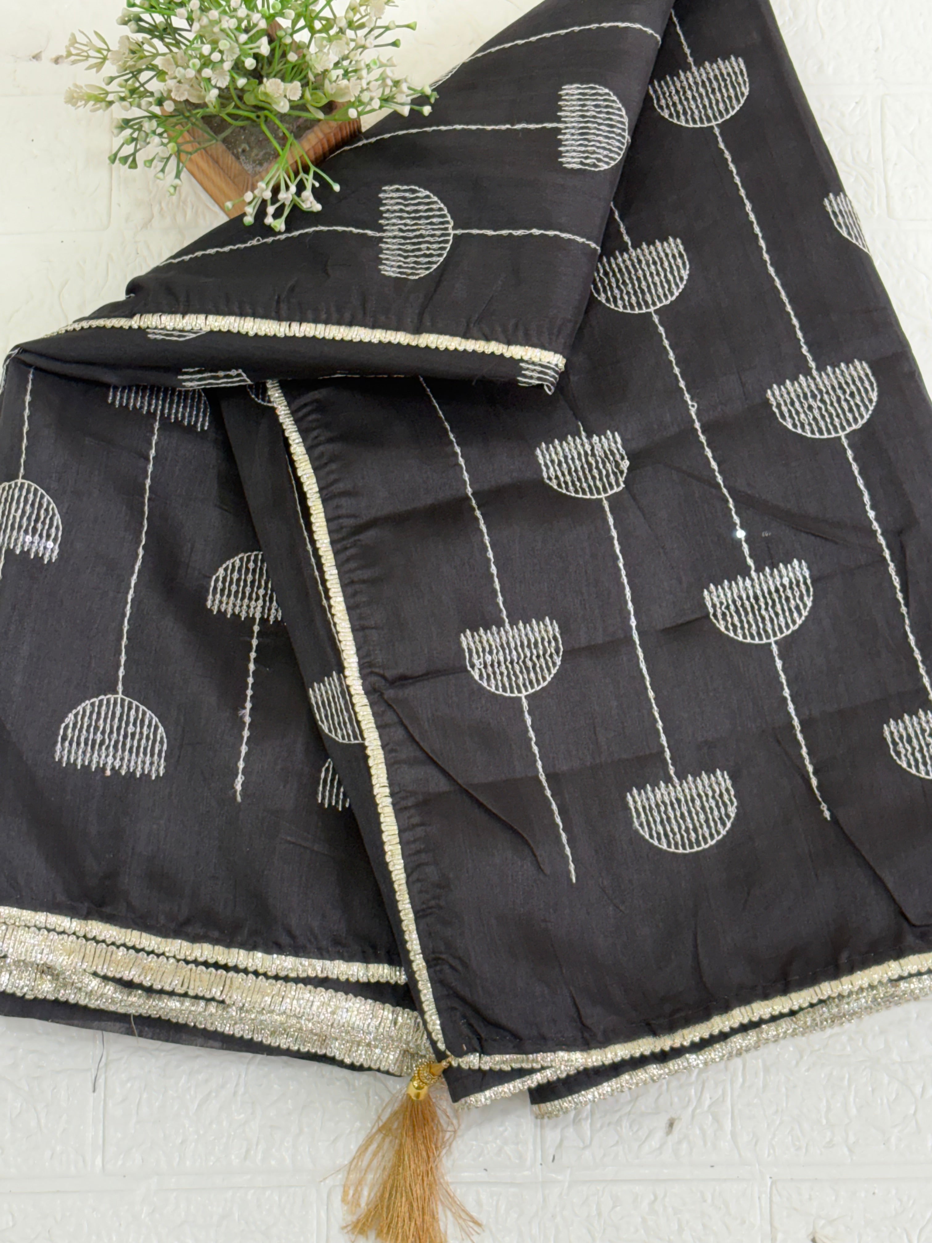 Name: Chanderi or Cotton Silk Saree The texture and slight sheen indicate a Chanderi or Cotton Silk Blend. With blouse The design features woven Zari lines/stripes and small thread/Aari embroidery motifs.