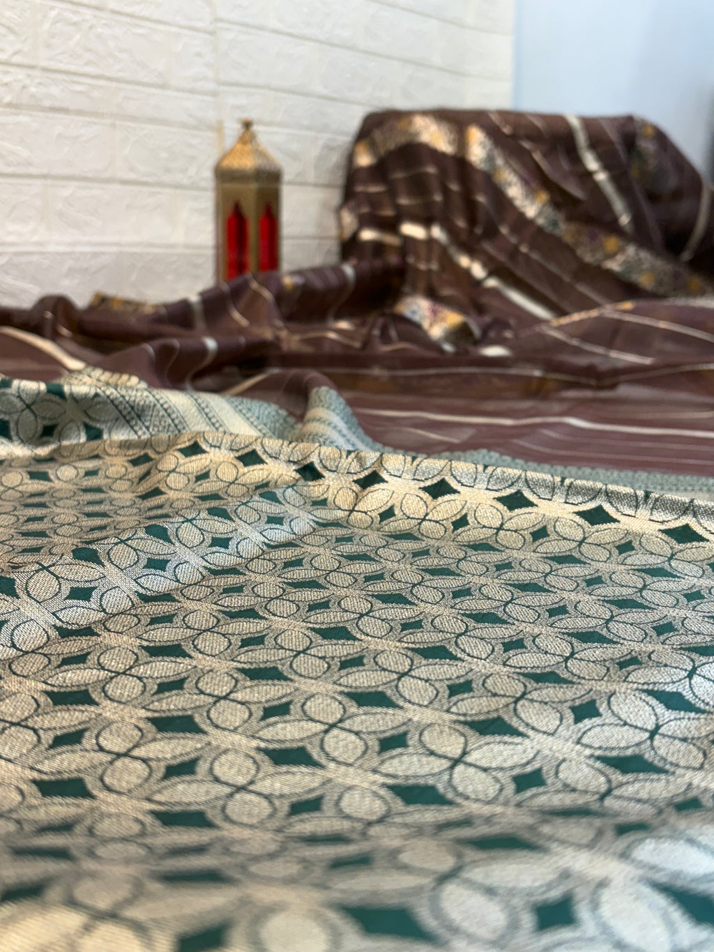 Dark brown zari Elegance Premium soft cotton saree with subtle zari stripes, floral butti accents, and a richly woven antique gold zari pallu and border for a classic, graceful look.